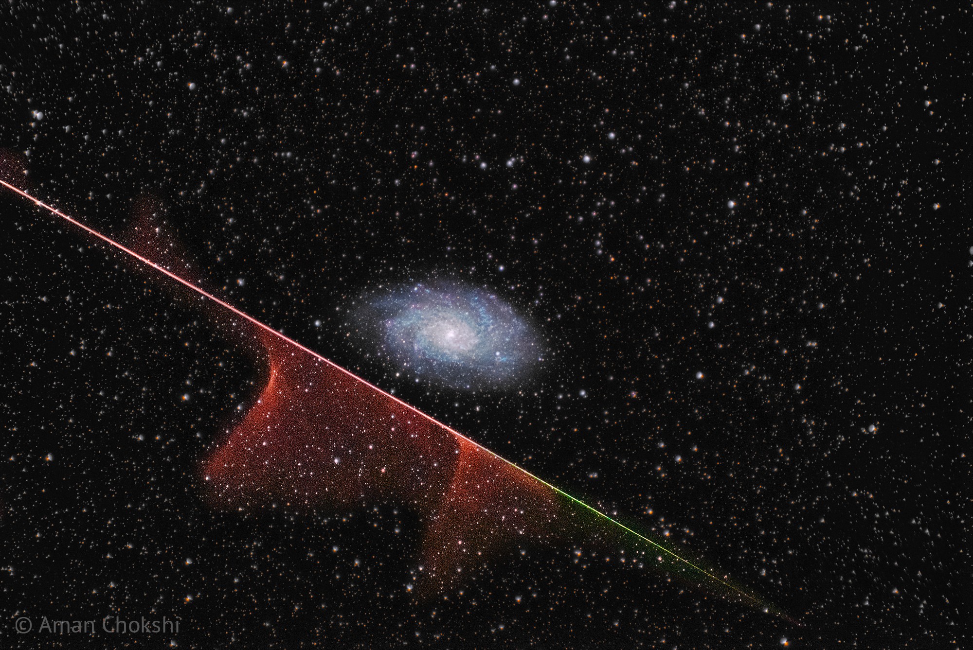 The galaxy was never in danger. For one thing, the Triangulum galaxy (M33), pictured, is much bigger than the tiny grain of rock at the head of the meteor. For another, the galaxy is much farther away -- in this instance 3 million light years as opposed to only about 0.0003 light seconds.  Even so, the meteor's path took it angularly below the galaxy. Also the wind high in Earth's atmosphere blew the meteor's glowing evaporative molecule train away from the galaxy, in angular projection.  Still, the astrophotographer was quite lucky to capture both a meteor and a galaxy in a single exposure -- which was subsequently added to two other images of M33 to bring up the spiral galaxy's colors.  At the end, the meteor was gone in a second, but the galaxy will last billions of years.   Your Sky Surprise: What picture did APOD feature on your birthday? (post 1995)