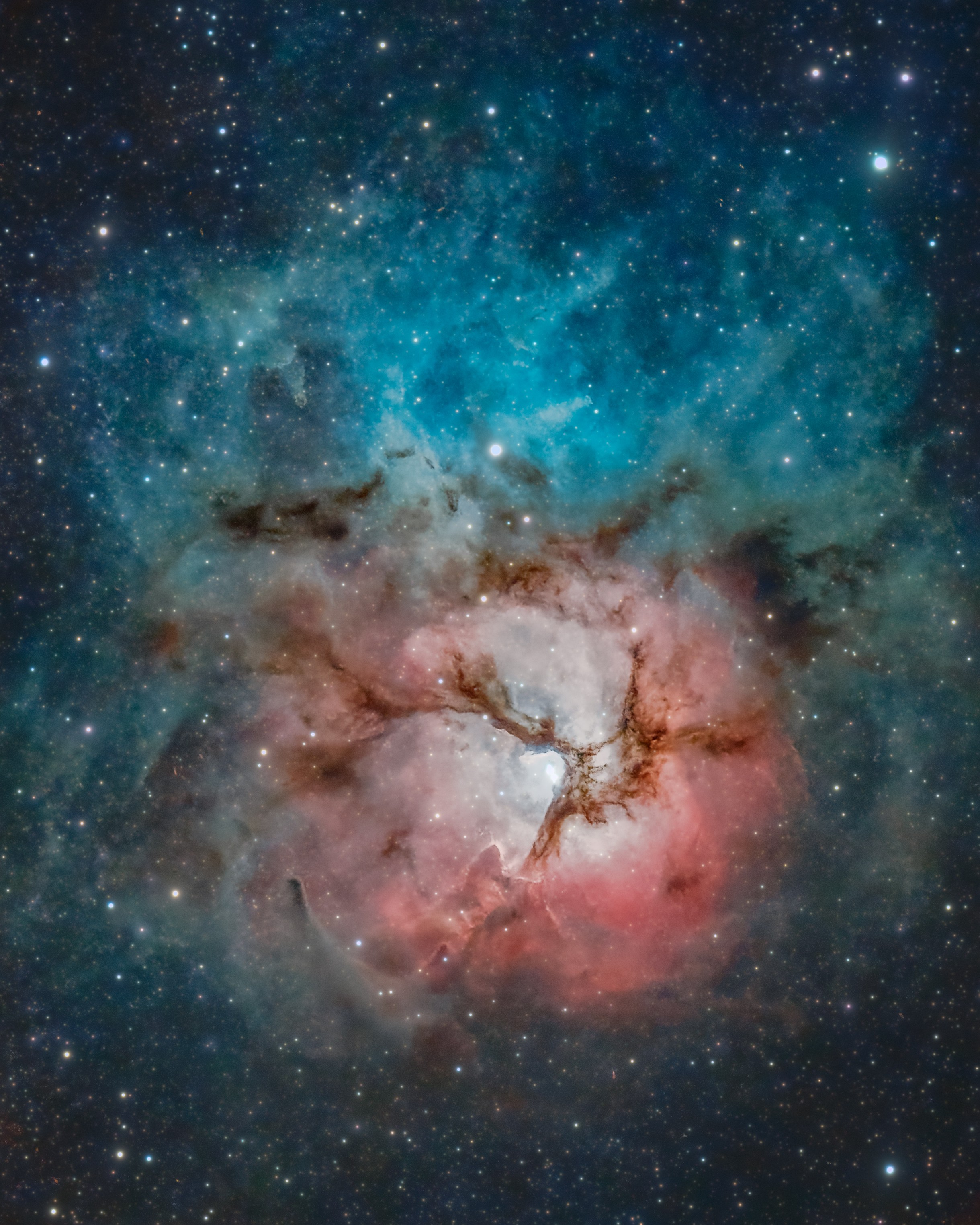 The beautiful Trifid Nebula is a cosmic study in contrasts. Also known as M20, it lies about 5,000 light-years away toward the nebula rich constellation Sagittarius. A star forming region in the plane of our galaxy, the Trifid does illustrate three different types of astronomical nebulae; red emission nebulae dominated by light from hydrogen atoms, blue reflection nebulae produced by dust reflecting starlight, and dark nebulae where dense dust clouds appear in silhouette. But the red emission region, roughly separated into three parts by obscuring dust lanes, is what lends the Trifid its popular name. Pillars and jets sculpted by newborn stars, above and right of the emission nebula's center, appear in famous Hubble Space Telescope close-up images of the region. The Trifid Nebula is about 40 light-years across. Too faint to be seen by the unaided eye, it almost covers the area of a full moon on planet Earth's sky.