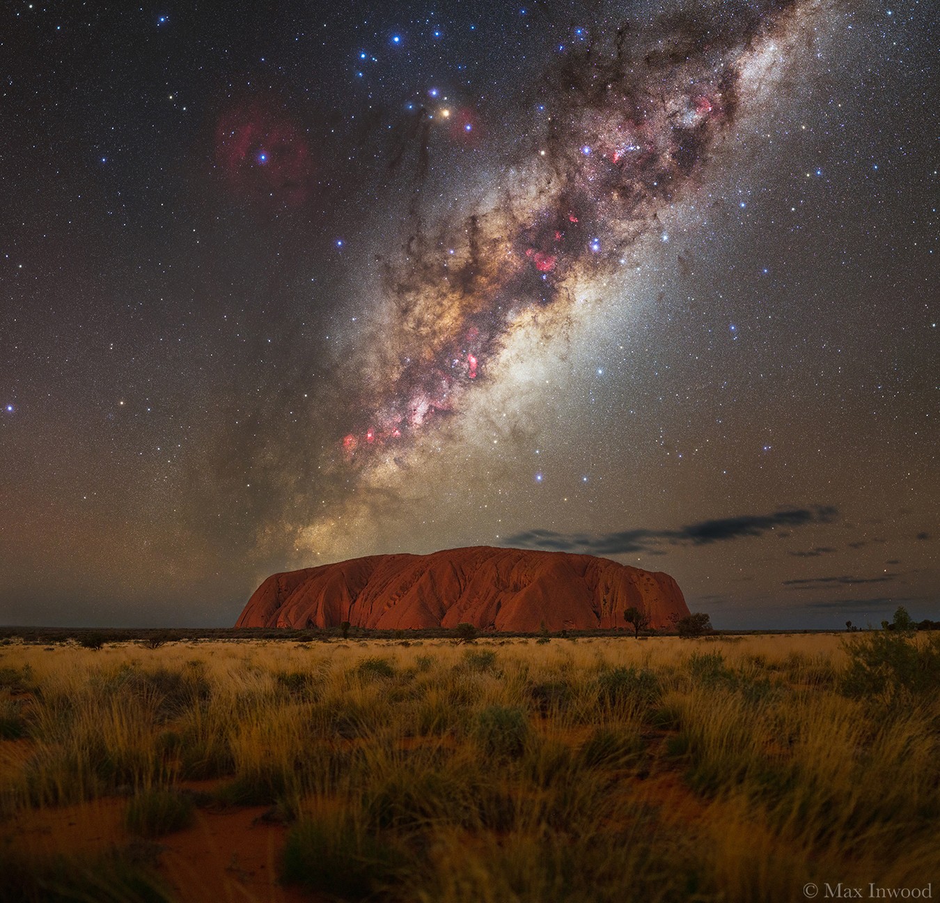 What's happening above Uluru?  A United Nations World Heritage Site, Uluru  is an extraordinary 350-meter high mountain in central Australia that rises sharply from nearly flat surroundings. Composed of sandstone, Uluru has slowly formed over the past 300 million years as softer rock eroded away.  The Uluru region has been a home to humans for over 22,000 years. Recorded  last month, the starry sky above Uluru includes the central band of our Milky Way galaxy, complete with complex dark filaments of dust, bright red emission nebulas, and billions of stars.