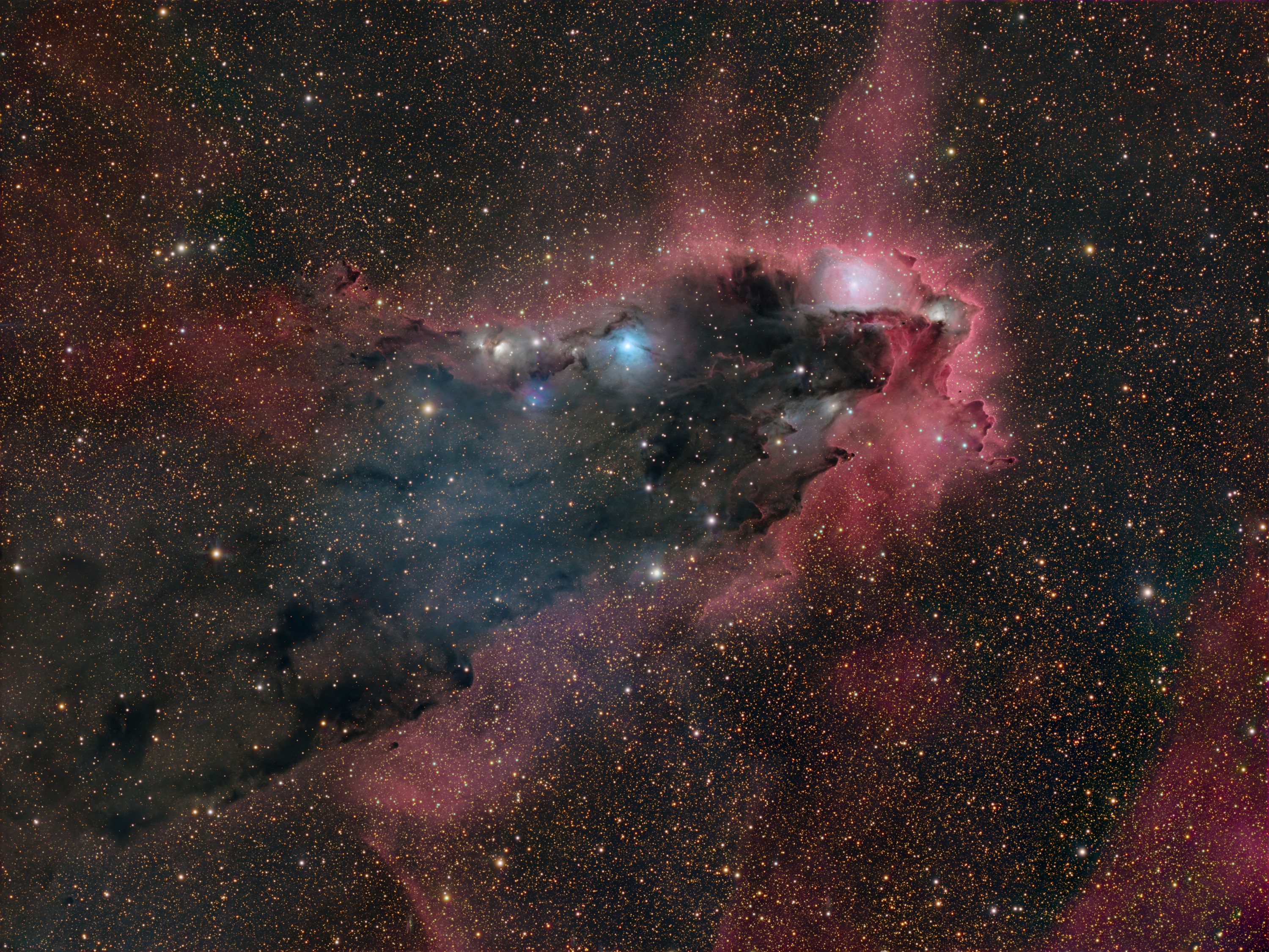 In silhouette against a crowded star field along the tail of the arachnological constellation Scorpius, this dusty cosmic cloud evokes for some the image of an ominous dark tower. In fact, monstrous clumps of dust and molecular gas collapsing to form stars may well lurk within the dark nebula, a structure that spans almost 40 light-years across this gorgeous telescopic portrait. A cometary globule, the swept-back cloud is shaped by intense ultraviolet radiation from the OB association of very hot stars in NGC 6231, off the upper right corner of the scene. That energetic ultraviolet light also powers the globule's bordering reddish glow of hydrogen gas. Hot stars embedded in the dust can be seen as bluish reflection nebulae. This dark tower and associated nebulae are about 5,000 light-years away.   Growing Gallery: Moon Eclipses Saturn in August 2024