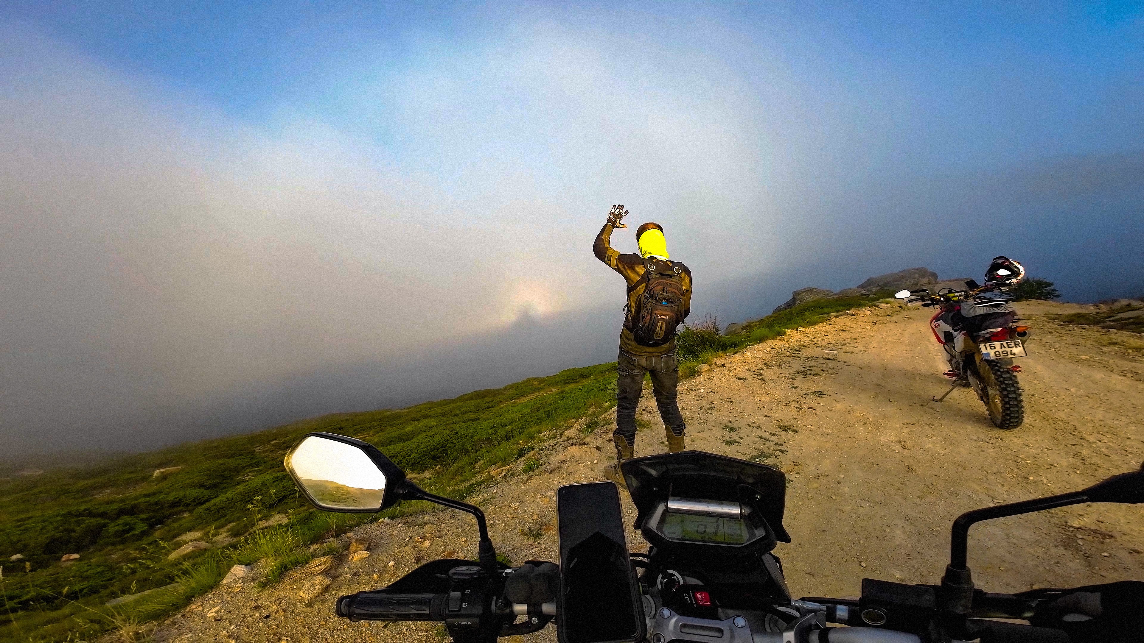 On a road trip up Mount Uludağ in Bursa province, Turkey these motorcyclists found themselves above low clouds and fog in late June. With the bright Sun directly behind them, the view down the side of the great mountain revealed a beautiful, atmospheric glory and fog bow. Known to some as the heiligenschein or the Specter of the Brocken, a glory can also sometimes be seen from airplanes or even high buildings. It often appears to be a dark giant surrounded by a bright halo. Of course the dark giant is just the shadow of the observer (90MB video) cast opposite the Sun. The clouds and fog are composed of very small water droplets, smaller than rain drops, that refract and reflect sunlight to create the glory's colorful halo and this more extensive fog bow.