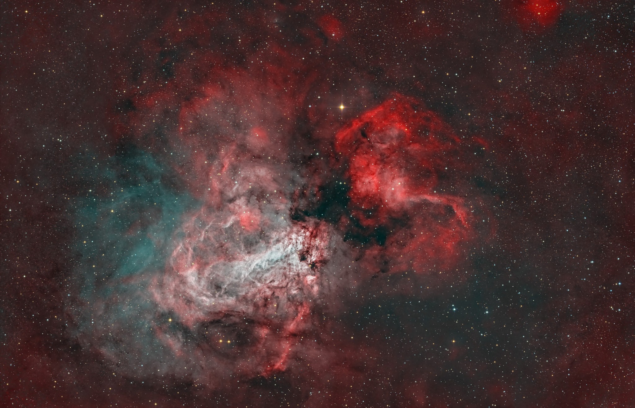 A nearby star factory known as Messier 17 lies some 5,500 light-years away in the nebula-rich constellation Sagittarius. At that distance, this 1.5 degree wide field-of-view would span about 150 light-years. In the sharp color composite image faint details of the region's gas and dust clouds are highlighted with narrowband image data against a backdrop of central Milky Way stars. The stellar winds and energetic radiation from hot, massive stars already formed from M17's stock of cosmic gas and dust have slowly carved away at the remaining interstellar material, producing the nebula's cavernous appearance and the undulating shapes within. A popular stop on telescopic tours of the cosmos, M17 is also known as the Omega or the Swan Nebula.