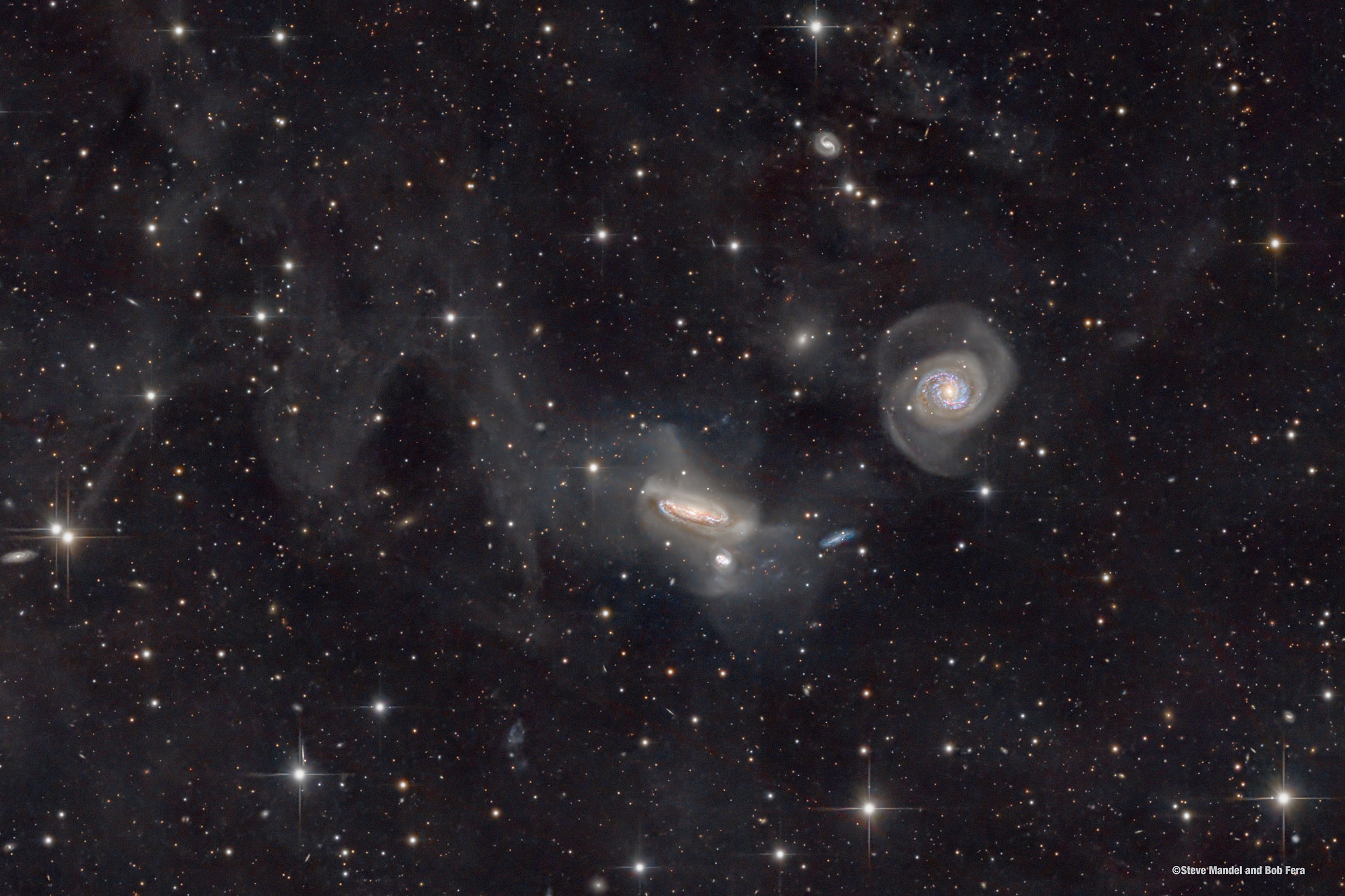 Galaxies of the NGC 7771 Group are featured in this intriguing skyscape. Some 200 million light-years distant toward the constellation Pegasus, NGC 7771 is the large, edge-on spiral near center, about 75,000 light-years across, with two smaller galaxies below it. Large spiral NGC 7769 is seen face-on to the right. Galaxies of the NGC 7771 group are interacting, making repeated close passages that will ultimately result in galaxy-galaxy mergers on a cosmic timescale. The interactions can be traced by distortions in the shape of the galaxies themselves and faint streams of stars created by their mutual gravitational tides. But a clear view of this galaxy group is difficult to come by as the deep image also reveals extensive clouds of foreground dust sweeping across the field of view. The dim, dusty galactic cirrus clouds are known as Integrated Flux Nebulae. The faint IFN reflect starlight from our own Milky Way Galaxy and lie only a few hundred light-years above the galactic plane.