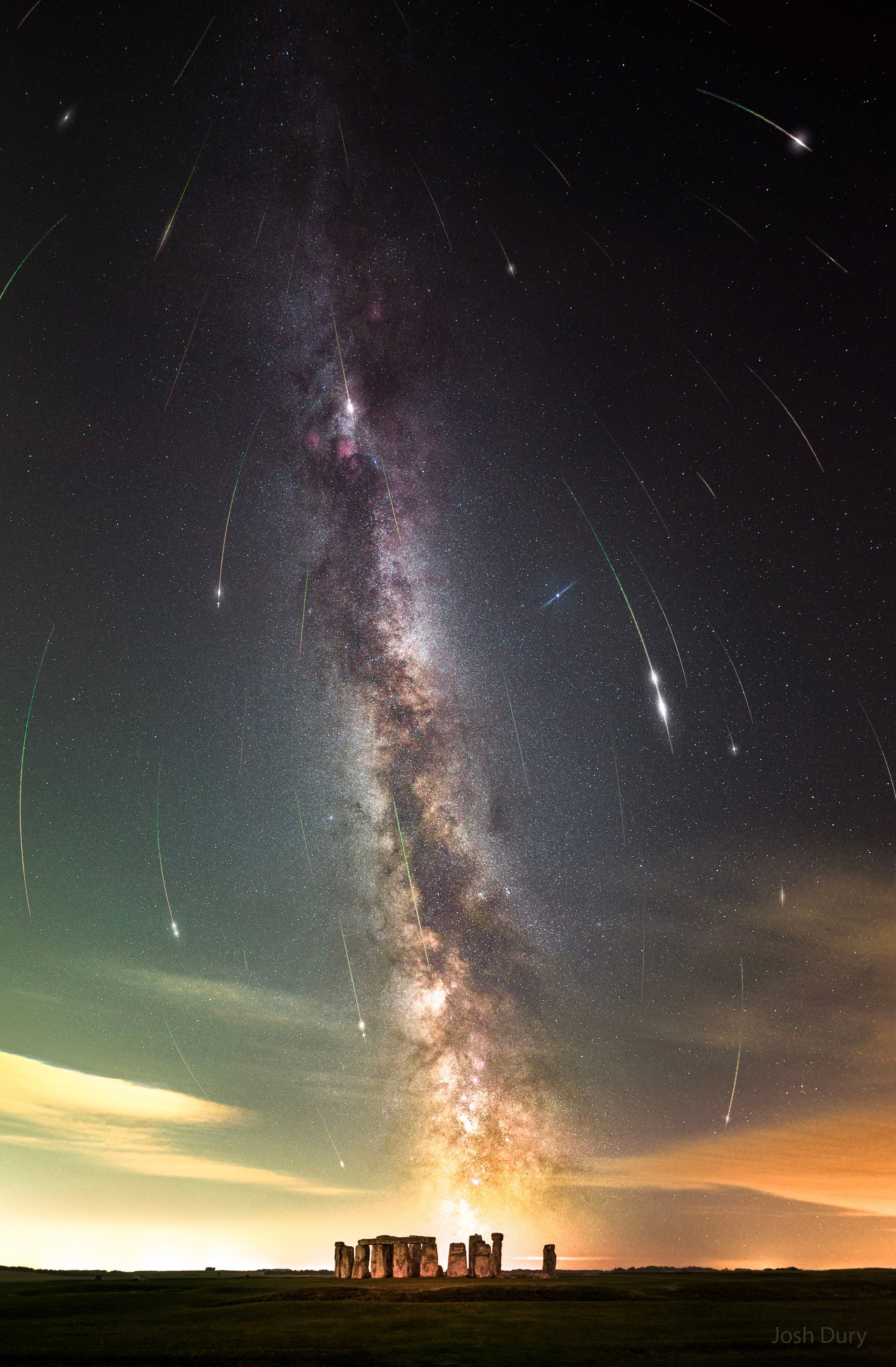 What's happening in the sky above Stonehenge? A meteor shower: specifically, the Perseid meteor shower. A few nights ago, after the sky darkened, many images of meteors from this year's Perseids were captured separately and merged into a single frame. Although the meteors all traveled on straight paths, these paths appear slightly curved by the wide-angle lens of the capturing camera. The meteor streaks can all be traced back to a single point on the sky called the radiant, here just off the top of the frame in the constellation of Perseus. The same camera took a deep image of the background sky that brought up the central band of our Milky Way galaxy running nearly vertical through the image center. The featured image was taken from Wiltshire, England, being careful to include, at the bottom, the famous astronomical monument of Stonehenge. Although the Perseids peaked last night, some Perseid meteors should still be visible for a few more nights.