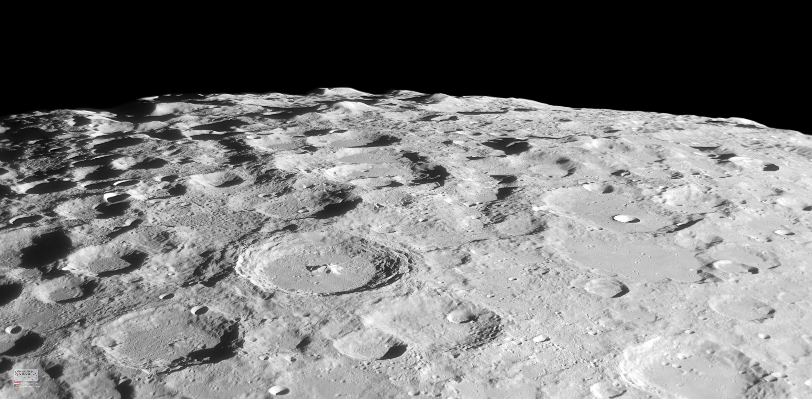 The Moon's south pole is toward the top left of this detailed telescopic moonscape. Captured on August 23, it looks across the rugged southern lunar highlands. The view's foreshortened perspective heightens the impression of a dense field of craters and makes the craters themselves appear more oval shaped close to the lunar limb. Prominent near center is 114 kilometer diameter crater Moretus. Moretus is young for a large lunar crater and features terraced inner walls and a 2.1 kilometer high, central peak, similar in appearance to the more northerly young crater Tycho. Mountains visible along the lunar limb at the top can rise about 6 kilometers or so above the surrounding terrain. Close to the lunar south pole, permanently shadowed crater floors with expected reservoirs of water-ice have made the rugged south polar region of the Moon a popular target for exploration.