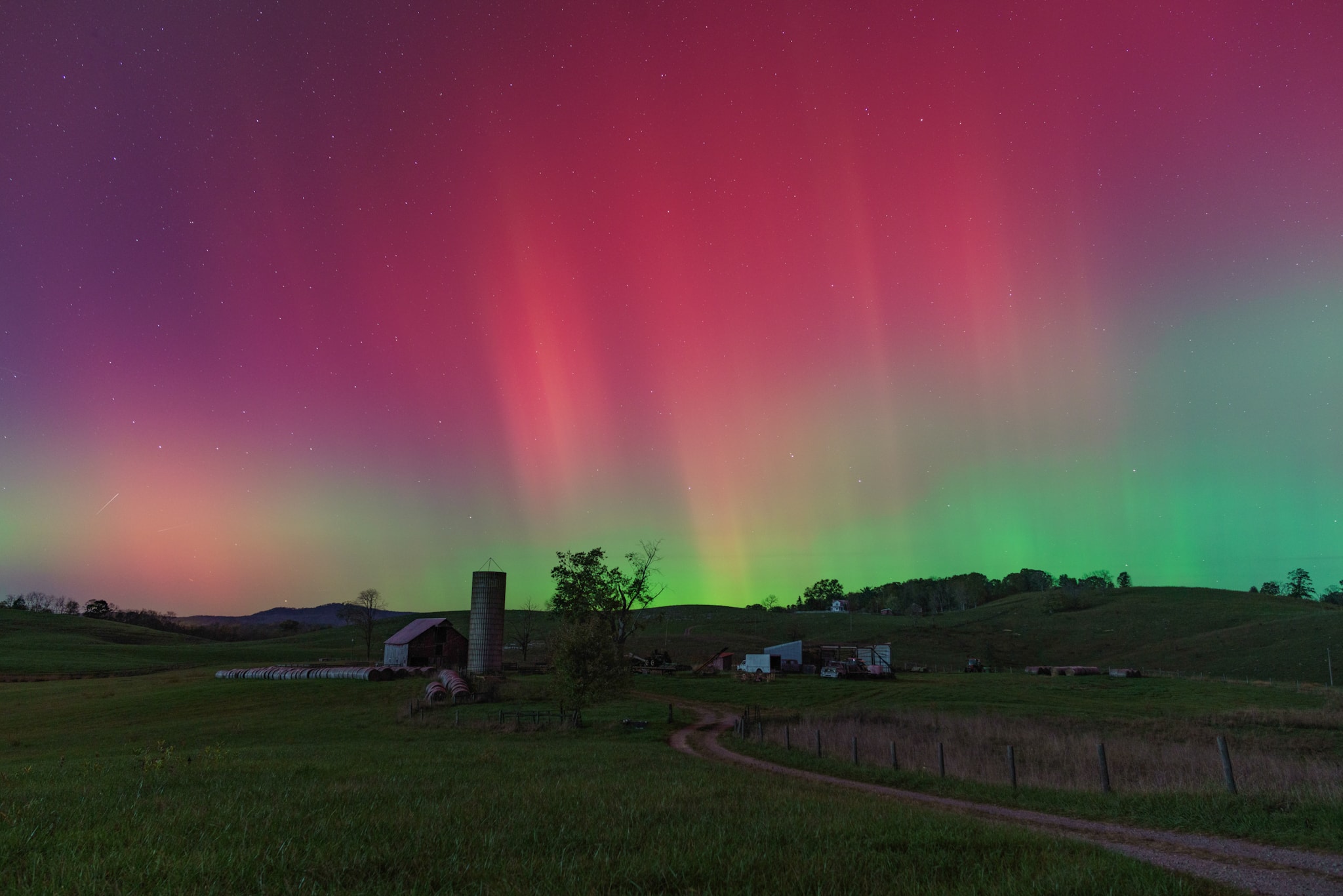 A gravel country lane gently winds through this colorful rural night skyscape. Captured from Monroe County in southern West Virginia on the evening of October 10, the starry sky above is a familiar sight. Shimmering curtains of aurora borealis or northern lights definitely do not make regular appearances here, though. Surprisingly vivid auroral displays were present on that night at very low latitudes around the globe, far from their usual northern and southern high latitude realms. The extensive auroral activity was evidence of a severe geomagnetic storm triggered by the impact of a coronal mass ejection (CME), an immense magnetized cloud of energetic plasma. The CME was launched toward Earth from the active Sun following a powerful X-class solar flare.   Growing Gallery: Global aurora during October 10/11, 2024