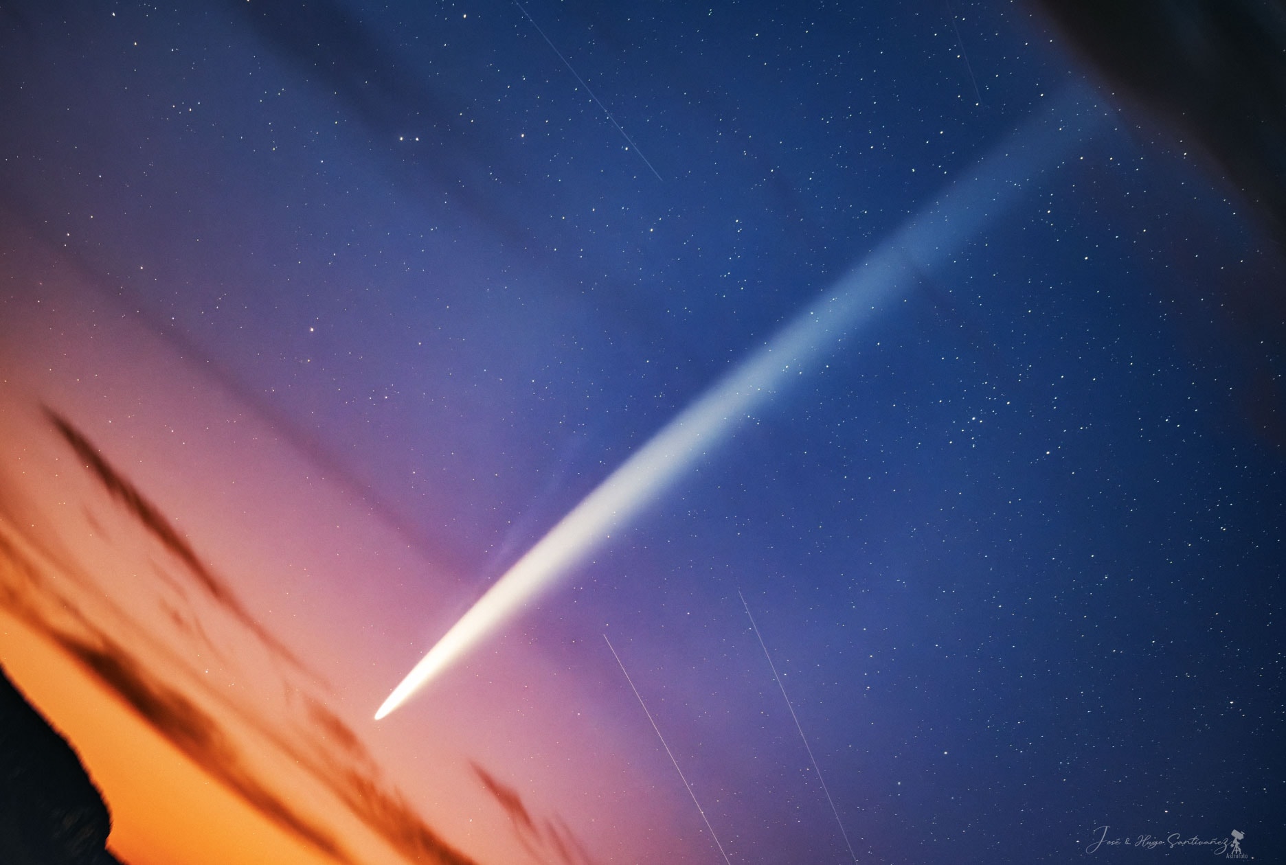 A bright comet is moving into the evening skies. C/2023 A3 (Tsuchinshan–ATLAS) has brightened and even though it is now easily visible to the unaided eye, it is so near to the Sun that it is still difficult to see. Pictured, Comet Tsuchinshan–ATLAS was captured just before sunrise from an Andes Mountain in Peru. Braving cold weather, this unusually high perch gave the astrophotographer such a low eastern horizon that the comet was obvious in the pre-dawn sky.  Visible in the featured image is not only an impressively long dust tail extending over many degrees, but an impressively long and blue ion tail, too.  This month, as the comet moves out from the Sun and passes the Earth, evening observers should be able to see the huge dirty ice ball toward the west just after sunset.   Growing Gallery: Comet Tsuchinsan-ATLAS in 2024