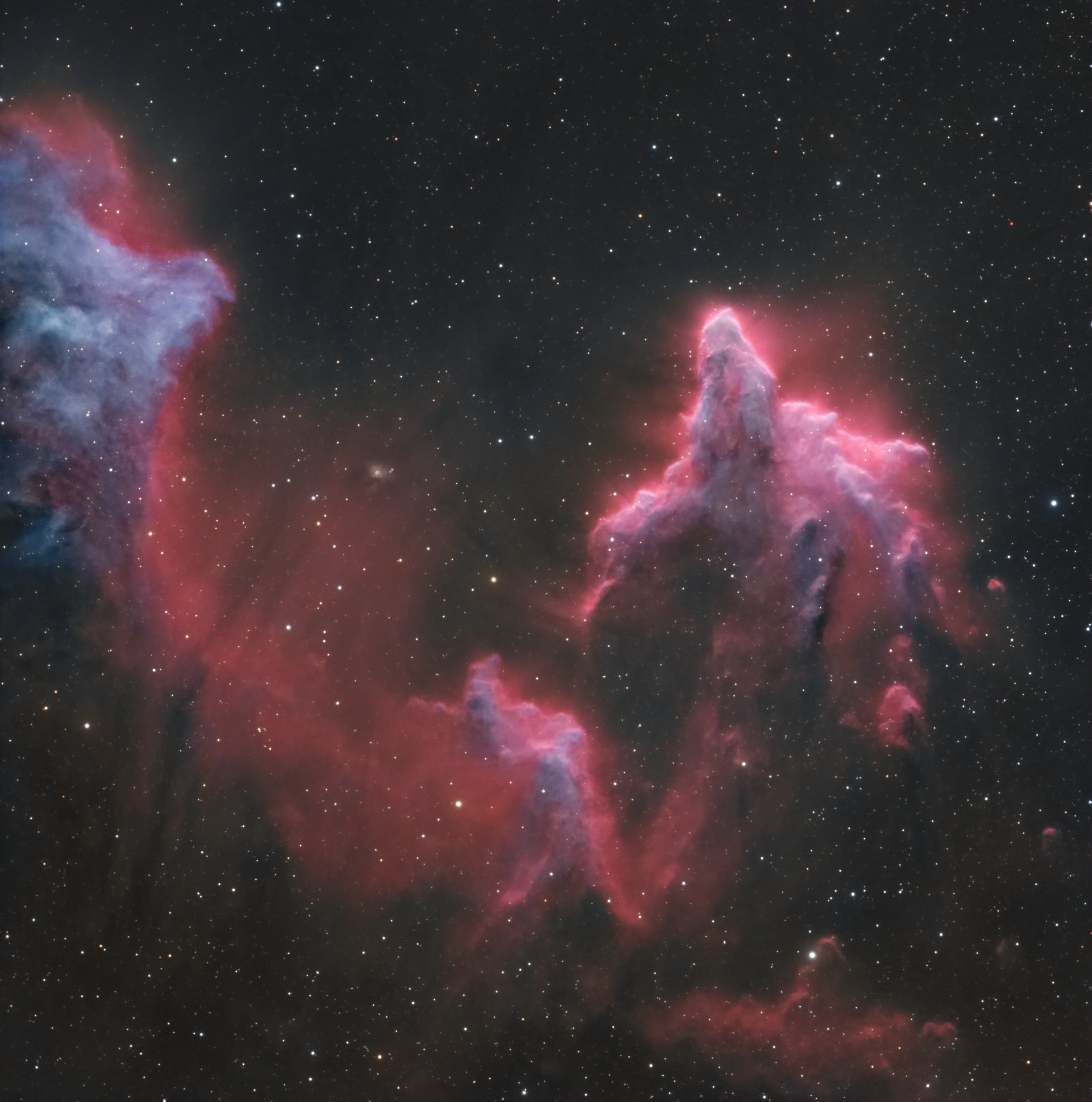 These brightly outlined flowing shapes look ghostly on a cosmic scale. A telescopic view toward the constellation Cassiopeia, the colorful skyscape features the swept-back, comet-shaped clouds IC 59 (left) and IC 63. About 600 light-years distant, the clouds aren't actually ghosts. They are slowly disappearing though, under the influence of energetic radiation from hot, luminous star gamma Cas. Gamma Cas is physically located only 3 to 4 light-years from the nebulae and lies just above the right edge of the frame. Slightly closer to gamma Cas, IC 63 is dominated by red H-alpha light emitted as hydrogen atoms ionized by the hot star's ultraviolet radiation recombine with electrons. Farther from the star, IC 59 shows less H-alpha emission but more of the characteristic blue tint of dust reflected star light. The field of view spans over 1 degree or 10 light-years at the estimated distance of the interstellar apparitions.