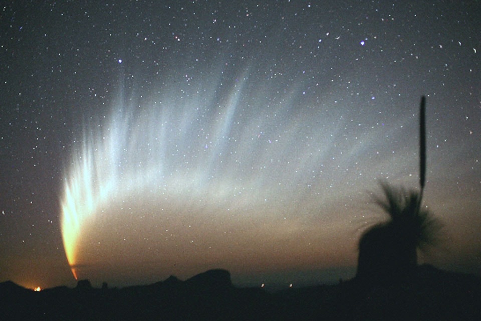 Comet McNaught, the Great Comet of 2007, grew a spectacularly long and filamentary tail.  The magnificent tail spread across the sky and was visible for several days to Southern Hemisphere observers just after sunset.  The amazing ion tail showed its greatest extent on long-duration, wide-angle camera exposures.  During some times, just the tail itself was visible just above the horizon for many northern observers as well. Comet C/2006 P1 (McNaught), estimated to have attained a peak brightness of  magnitude -5 (minus five), was caught by the comet's discoverer in the featured image just after sunset in January 2007 from Siding Spring Observatory in Australia. Comet McNaught, the brightest comet in decades, then  faded as it moved further into southern skies and away from the Sun and Earth. Over the next month, Comet Tsuchinshan–ATLAS, a candidate for the Great Comet of 2024, should display its most spectacular tails  visible from the Earth.