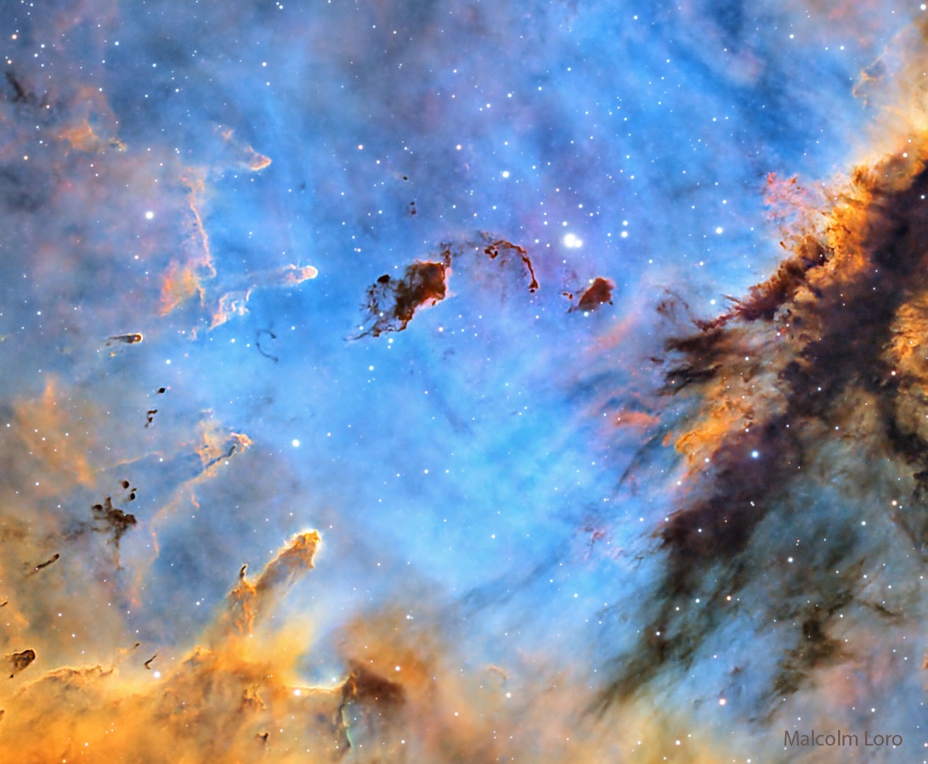 Stars can create huge and intricate dust sculptures from the dense and dark molecular clouds from which they are born.  The tools the stars use to carve their detailed works are high energy light and fast stellar winds.  The heat they generate evaporates the dark molecular dust as well as causing ambient hydrogen gas to disperse and glow.   Pictured here, a new open cluster of stars designated IC 1590 is nearing completion around the intricate interstellar dust structures in the emission nebula  NGC 281, dubbed the Pac-man Nebula because of its overall shape.  The dust cloud just above center is classified as a  Bok Globule as it may gravitationally collapse and form a star -- or stars. The Pacman Nebula lies about 10,000 light years away toward the constellation of Cassiopeia.