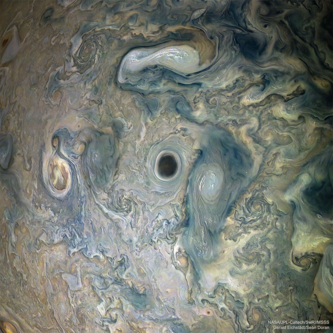 What's that black spot on Jupiter? No one is sure.  During one pass of NASA's Juno over  Jupiter, the robotic spacecraft imaged an usually dark cloud feature informally dubbed the Abyss. Surrounding cloud patterns show the Abyss to be at the center of a vortex. Since dark features on Jupiter's atmosphere tend to run deeper than light features, the Abyss may really be the deep hole that it appears -- but without more evidence that remains conjecture.  The Abyss is surrounded by a complex of meandering clouds and other swirling storm systems, some of which are topped by light colored, high-altitude clouds.  The featured image was captured in 2019 while Juno passed only about 15,000 kilometers above Jupiter's cloud tops.  The next close pass of Juno near Jupiter will be in about three weeks.