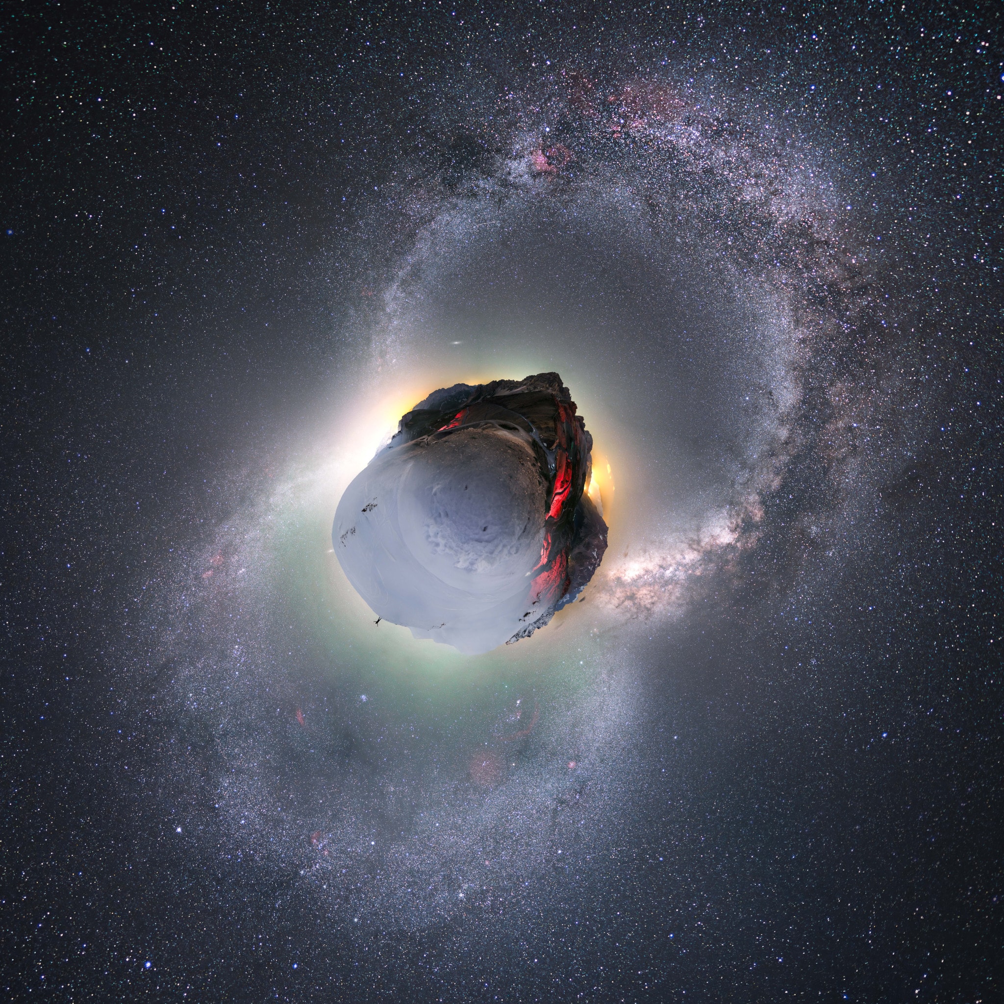 Winter and summer appear to come on a single night to this stunning little planet. It's planet Earth of course. The digitally mapped, nadir centered panorama covers 360x180 degrees and is composed of frames recorded during January and July from the Col du Galibier in the French Alps. Stars and nebulae of the northern winter (bottom) and summer Milky Way form the complete arcs traversing the rugged, curved horizon. Cars driving along on the road during a summer night illuminate the 2,642 meter high mountain pass, but snow makes access difficult during winter months except by serious ski touring. Cycling fans will recognize the Col du Galibier as one of the most famous climbs in planet Earth's Tour de France.