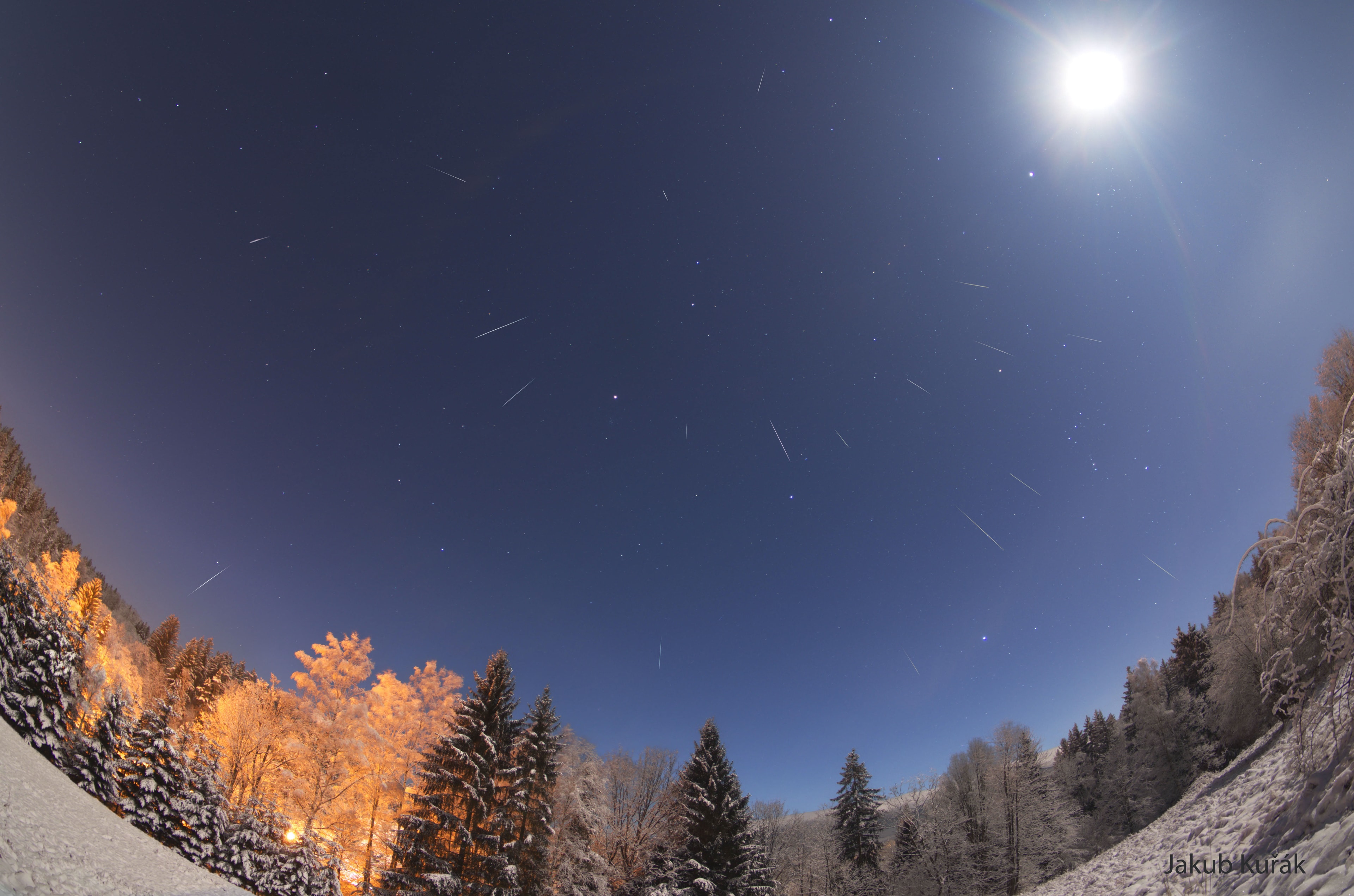 Meteors have been flowing out from the constellation Gemini.  This was expected, as mid-December is the time of the Geminid Meteor Shower.  Pictured here, over two dozen meteors were caught in successively added exposures taken over several hours early Saturday morning from a snowy forest in Poland. The fleeting streaks were bright enough to be seen over the din of the nearly full Moon on the upper right. These streaks can all be traced back to a point on the sky called the radiant toward the bright stars Pollux and Castor in the image center. The Geminid meteors started as sand sized bits expelled from asteroid 3200 Phaethon during its elliptical orbit through the inner Solar System.    Jigsaw Challenge: Astronomy Puzzle of the Day