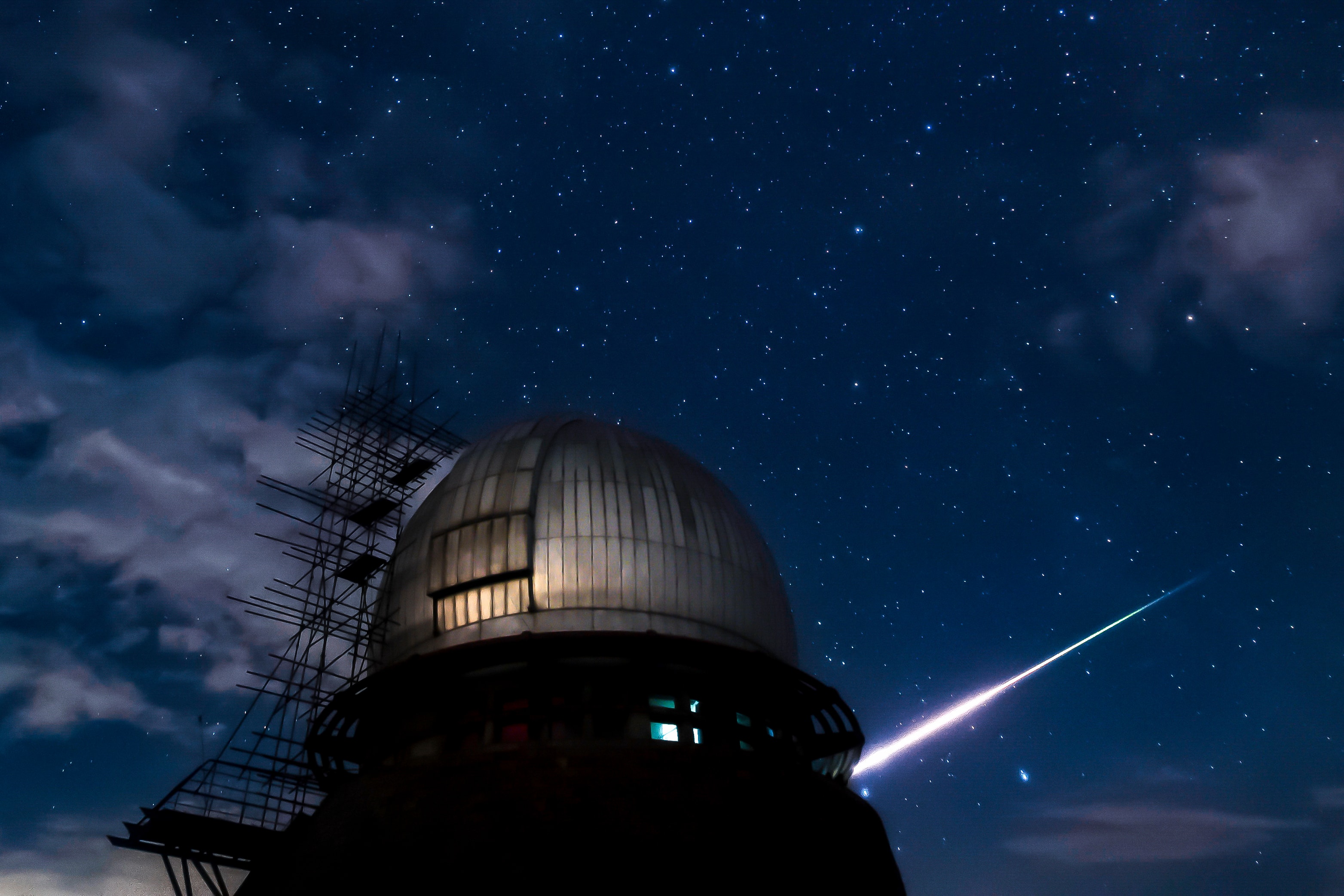 Colorful and bright, this streaking fireball meteor was captured in a single exposure taken at Purple Mountain (Tsuchinshan) Observatory’s Xuyi Station in 2020, during planet Earth's annual Perseid meteor shower. The dome in the foreground houses the China Near Earth Object Survey Telescope (CNEOST), the largest multi-purpose Schmidt telescope in China. Located in Xuyi County, Jiangsu Province, the station began its operation as an extension of China's Purple Mountain Observatory in 2006. Darling of planet Earth's night skies in 2024, the bright comet designated Tsuchinshan-ATLAS (C/2023 A3) was discovered in images taken there on 2023 January 9. The discovery is jointly credited to NASA's ATLAS robotic survey telescope at Sutherland Observatory, South Africa. Other comet discoveries associated with the historic Purple Mountain Observatory and bearing the observatory's transliterated Mandarin name include periodic comets 60/P Tsuchinshan and 62/P Tsuchinshan.