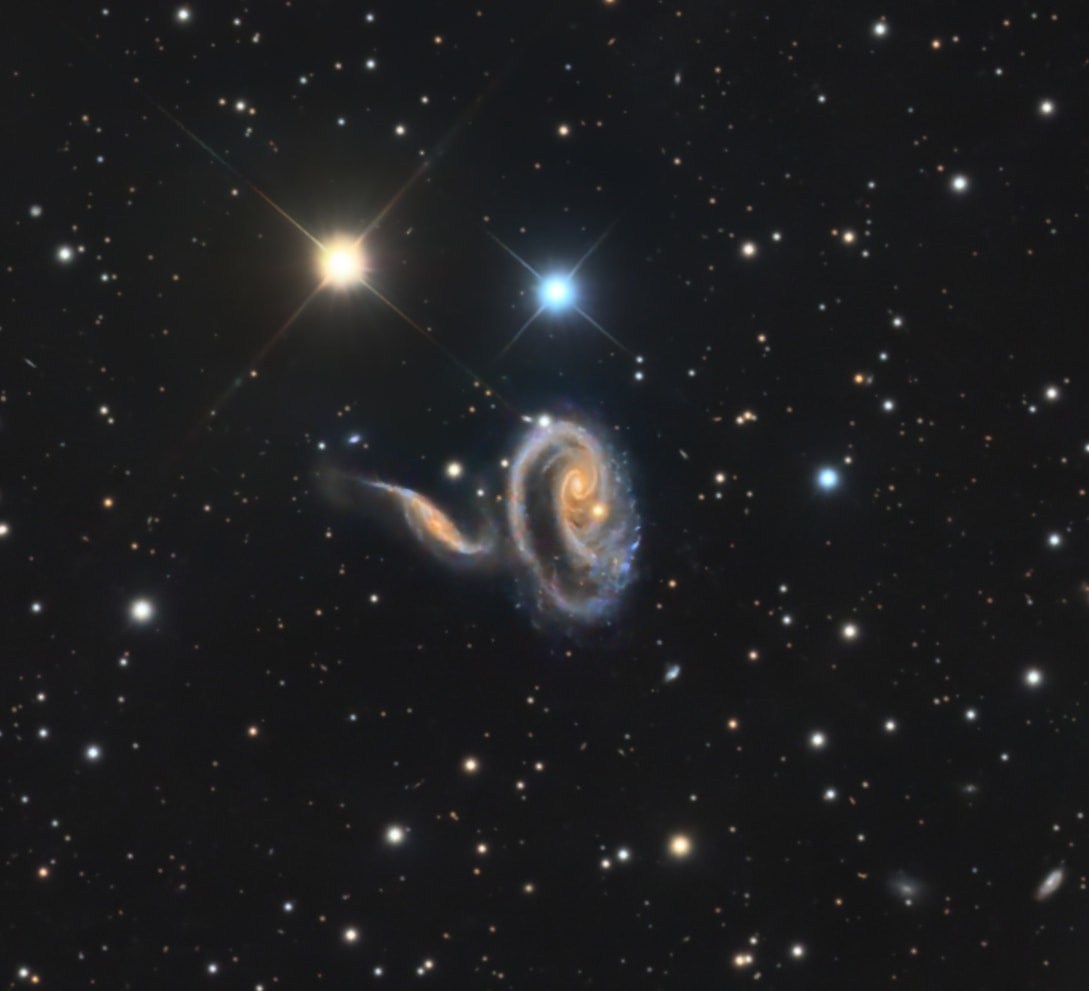 The colorful, spiky stars are in the foreground of this image taken with a small telescope on planet Earth. They lie well within our own Milky Way Galaxy. But the two eye-catching galaxies in the frame lie far beyond the Milky Way, at a distance of over 300 million light-years. The galaxies' twisted and distorted appearance is due to mutual gravitational tides as the pair engage in close encounters. Cataloged as Arp 273 (also as UGC 1810), these galaxies do look peculiar, but interacting galaxies are now understood to be common in the universe. Closer to home, the large spiral Andromeda Galaxy is known to be some 2 million light-years away and inexorably approaching the Milky Way.  In fact the far away peculiar galaxies of Arp 273 may offer an analog of the far future encounter of Andromeda and Milky Way. Repeated galaxy encounters on a cosmic timescale ultimately result in a merger into a single galaxy of stars. From our perspective, the bright cores of the Arp 273 galaxies are separated by only a little over 100,000 light-years.