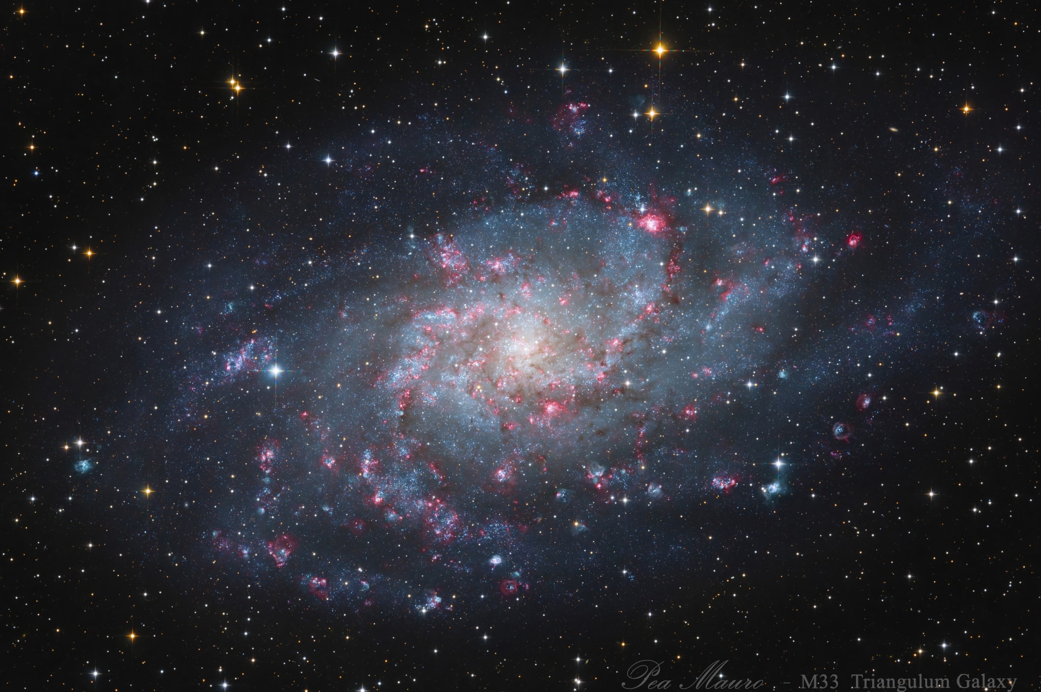 Gorgeous spiral galaxy Messier 33 seems to have more than its fair share of glowing hydrogen gas. A prominent member of the Local Group of galaxies, M33 is also known as the Triangulum Galaxy and lies a mere 3 million light-years away.  The galaxy's central 60,000 light-years or so are shown in this sharp galaxy portrait. The portrait features M33's reddish ionized hydrogen clouds or HII regions. Sprawling along loose spiral arms that wind toward the core, M33's giant HII regions are some of the largest known stellar nurseries, sites of the formation of short-lived but very massive stars. Intense ultraviolet radiation from the luminous, massive stars ionizes the surrounding hydrogen gas and ultimately produces the characteristic red glow. In this image, broadband data were combined with narrowband data recorded through a filter that transmits the light of the strongest visible hydrogen and oxygen emission lines.