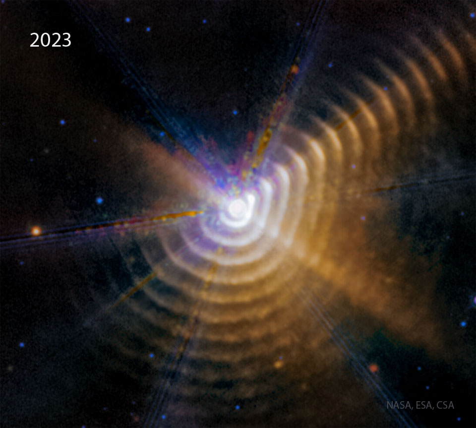 What are those strange rings? Rich in dust, the rings are likely 3D shells -- but how they were created remains a topic of research.  Where they were created is well known: in a binary star system that lies about 6,000 light years away toward the constellation of the Swan (Cygnus) -- a system dominated by the Wolf-Rayet star WR 140.  Wolf-Rayet stars are massive, bright, and known for their tumultuous winds. They are also known for creating and dispersing heavy elements such as carbon, which is a building block of interstellar dust. The other star in the binary is also bright and massive -- but not as active.  The two great stars joust in an oblong orbit as they approach each other about every eight years. When at closest approach, the X-ray emission from the system increases, as, apparently, does the dust expelled into space -- creating another shell.  The featured infrared image by the Webb Space Telescope resolves greater details and more dust shells than ever before. Images taken over consecutive years show the shells moving outward.