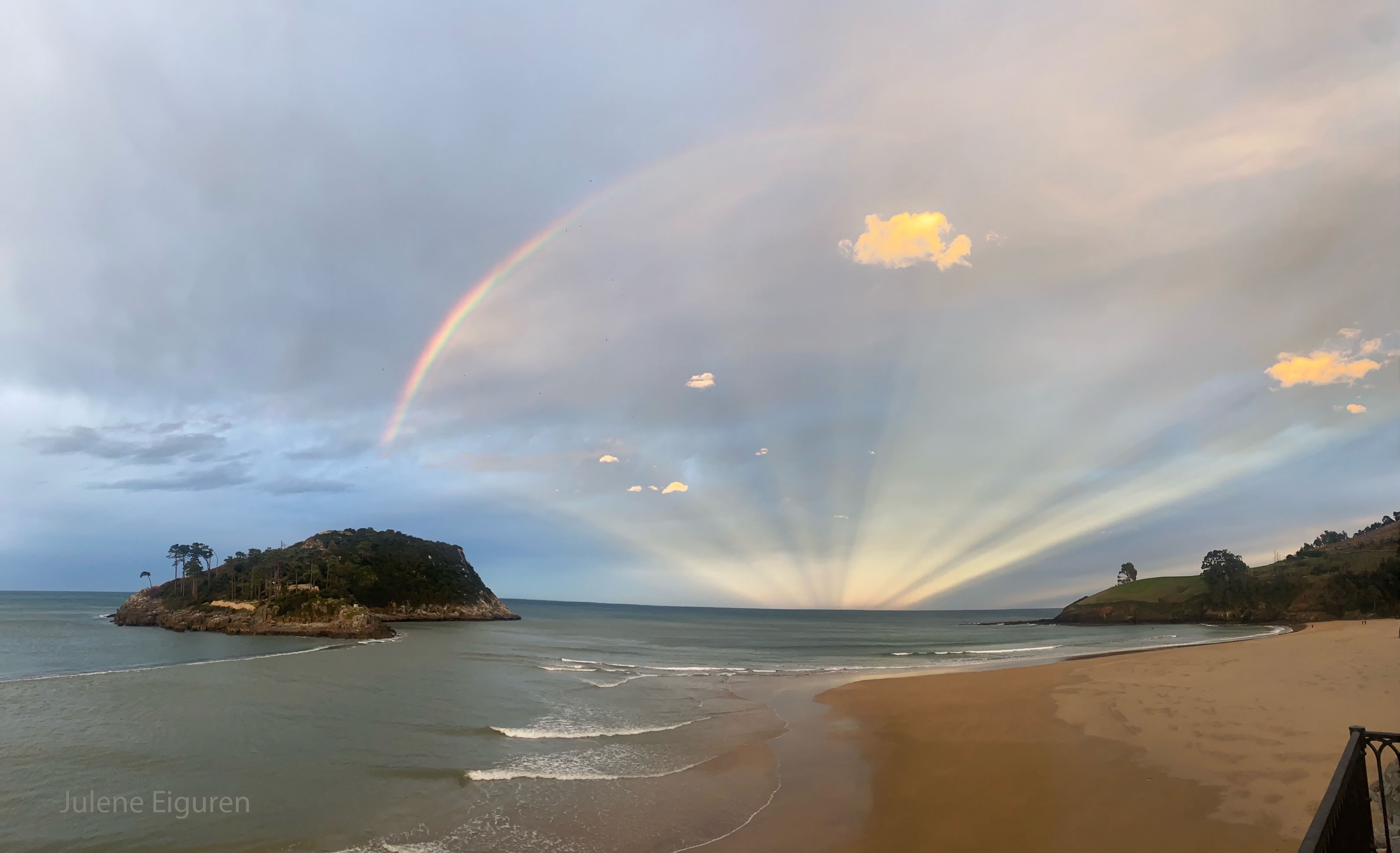 Yes, but can your rainbow do this? Late in the day, the Sun set as usual toward the west. However, on this day, the more interesting display was 180 degrees around -- toward the east. There, not only was a rainbow visible, but an impressive display of anticrepuscular rays from the rainbow's center. In the featured image from Lekeitio in northern Spain, the Sun is behind the camera. The rainbow resulted from sunlight reflecting back from falling rain. Anticrepuscular rays result from sunlight, blocked by some clouds, going all the way around the sky, overhead, and appearing to converge on the opposite horizon -- an optical illusion.  Rainbows by themselves can be exciting to see, and anticrepuscular rays a rare treat, but capturing them both together is even more unusual -- and can look both serene and surreal.   Jigsaw Challenge: Astronomy Puzzle of the Day