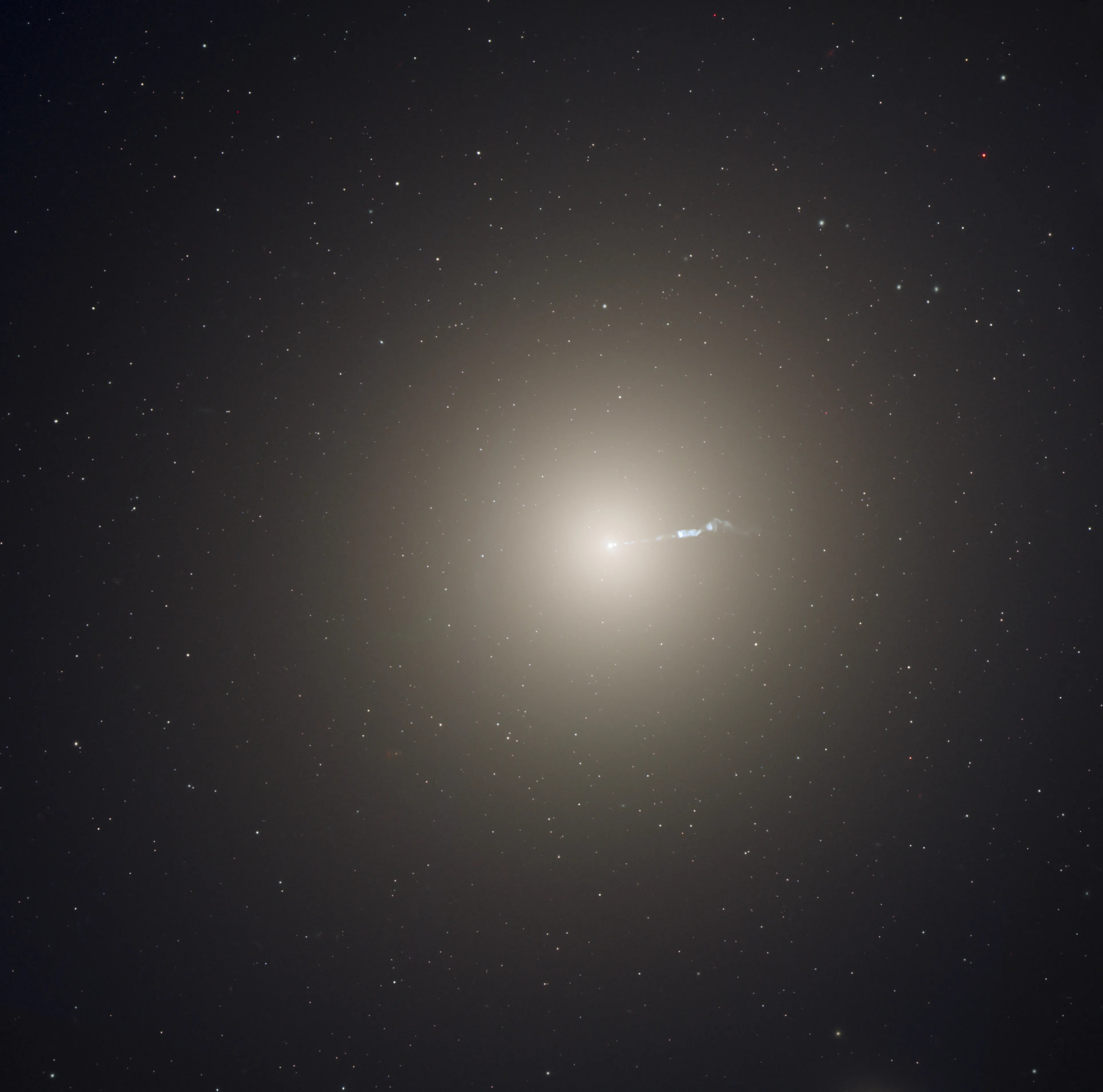 rmous elliptical galaxy Messier 87 is about 50 million light-years away. Also known as NGC 4486, the giant galaxy holds trillions of stars compared to the mere billions of stars in our large spiral Milky Way. M87 reigns as the large central elliptical galaxy in the Virgo galaxy cluster. An energetic jet from the giant galaxy's core is seen to stretch outward for about 5,000 light-years in this sharp optical and near-infrared view from the Hubble Space Telescope. In fact, the cosmic blow torch is seen across the electromagnetic spectrum from gamma-rays to radio wavelengths. Its ultimate power source is M87's central, supermassive black hole. An image of this monster in the middle of M87 has been captured by planet Earth's Event Horizon Telescope.