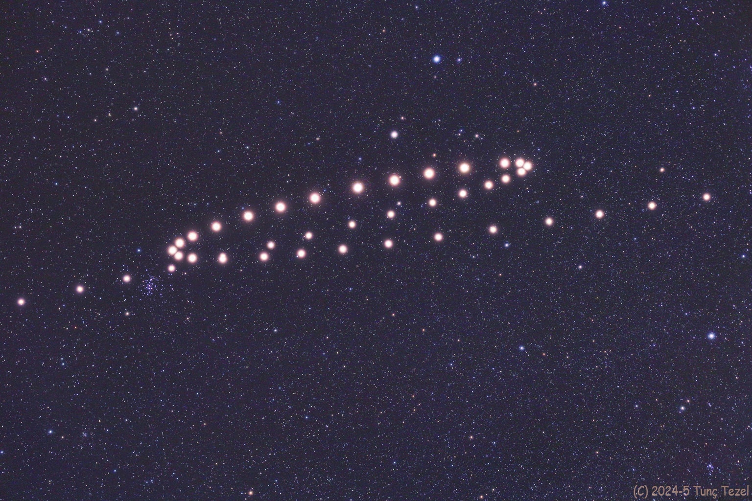 This composite of images spaced a weather-permitting 5 to 9 days apart, from 2024 September 19 (top right) through 2025 May 18 (bottom left), faithfully traces ruddy-colored Mars as it makes a clockwise loop through the constellations Gemini and Cancer in planet Earth's night sky. You can connect the dots and dates with your cursor over the image, but be sure to check out this animation of the Red Planet's 2024/25 retrograde motion. Of course Mars didn't actually reverse the direction of its orbit. Instead, the apparent backwards motion with respect to the background stars is a reflection of the orbital motion of Earth itself. Retrograde motion can be seen each time Earth overtakes and laps planets orbiting farther from the Sun, the Earth moving more rapidly through its own relatively close-in orbit.  In this case Mars' apparent eastward motion began to reverse around December 8, when it seemed to linger near open star cluster M44 in Cancer. After wandering back to the west, under Gemini's bright stars Castor and Pollux, Mars returned to pose near M44 by early May. At its brightest near opposition on 2025 January 16, Mars was a mere 96 million kilometers away.