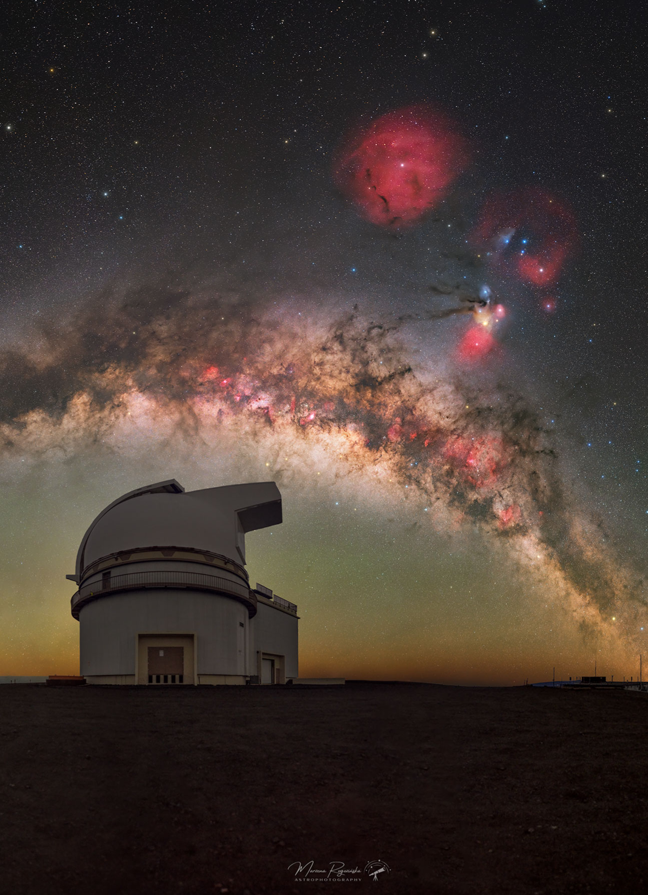 Have you ever seen the band of our Milky Way Galaxy?  In a clear sky from a dark location at the right time, a faint band of light becomes visible across the sky.  Soon after your eyes become dark adapted, you might spot the band for the first time.  It may then become obvious.  Then spectacular.  One reason for your growing astonishment might be the realization that this fuzzy swath, the Milky Way, contains billions of stars.  Visible in the featured image, high above in the night sky, the band of the Milky Way Galaxy arcs.  Also visible are the colorful clouds of Rho Ophiuchi on the right, and the red and circular Zeta Ophiuchi nebula near the top center. Taken in late February from Maunakea, Hawaii, USA, the foreground telescope is the University of Hawaii's 2.2-Meter Telescope. Fortunately, you don’t need to be near the top of a Hawaiian volcano to see the Milky Way.    Put it All Together: Astronomy Puzzle of the Day