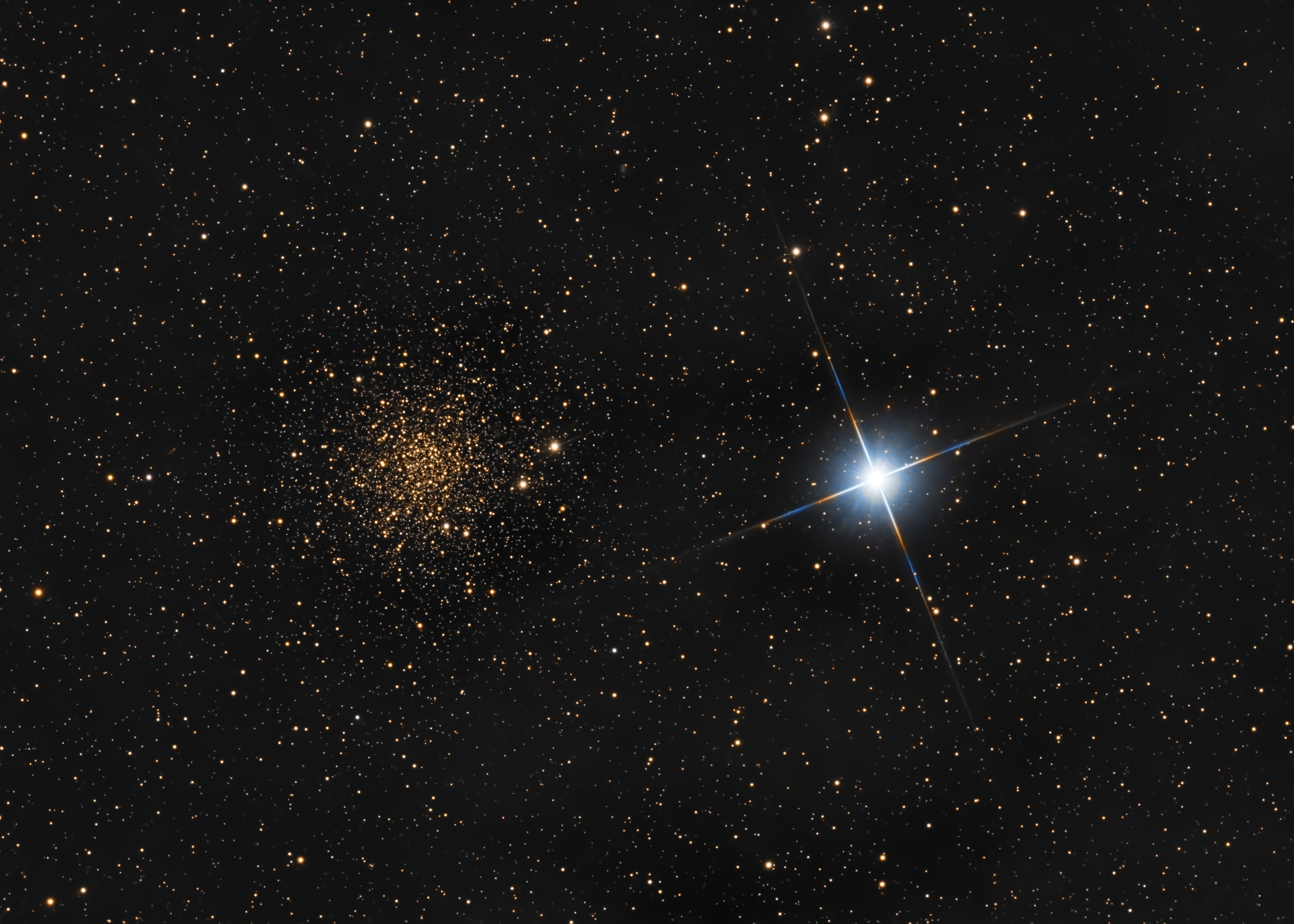 Most globular star clusters roam the halo of our Milky Way galaxy, but globular cluster NGC 6366 lies close to the galactic plane. About 12,000 light-years away toward the constellation Ophiuchus, the cluster's starlight is dimmed and reddened by the Milky Way's interstellar dust when viewed from planet Earth. As a result, the stars of NGC 6366 look almost golden in this telescopic scene, especially when seen next to relatively bright, bluish, and nearby star 47 Ophiuchi. Compared to the hundred thousand stars or so gravitationally bound in distant NGC 6366, 47 Oph itself is a binary star system  a mere 100 light-years away. Still, the co-orbiting stars of 47 Oph are too close together to be individually distinguished in the image.