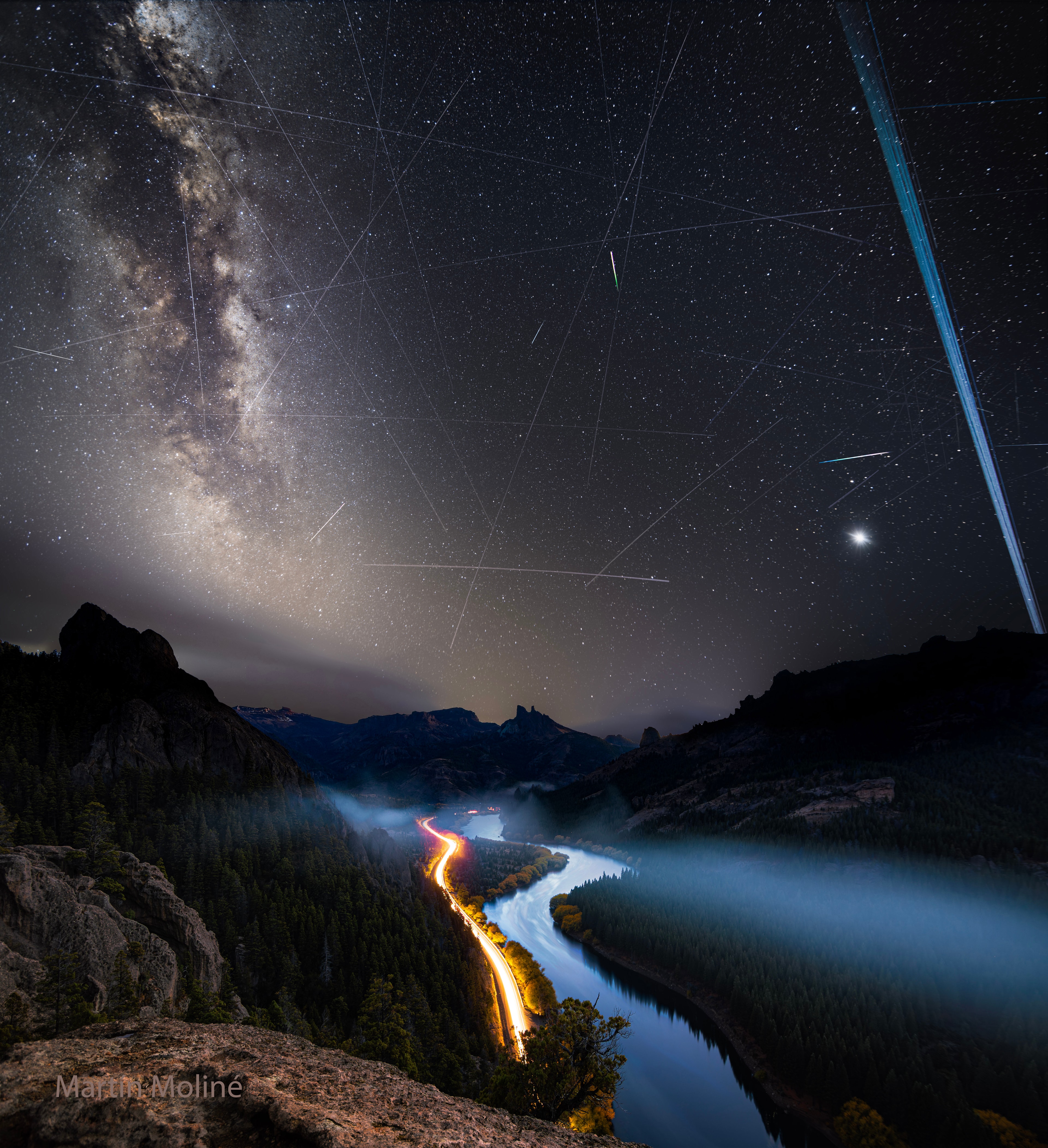 What are all those streaks in the sky? A galaxy, many satellite trails, and a few meteors.  First, far in the distance, the majestic band of our Milky Way Galaxy runs down the left. Mirroring it on the right are several parallel trails of Earth-orbiting Starlink satellites. Many fainter satellite trails also crisscross the image. The two short and bright streaks are meteors — likely members of the annual Eta Aquariids meteor shower.  The planet Venus shines on the lower right.  Venus and the satellites shine by reflected sunlight. The featured picture is a composite of exposures all taken in a few hours on May 4 over the Limay River in Argentina.
