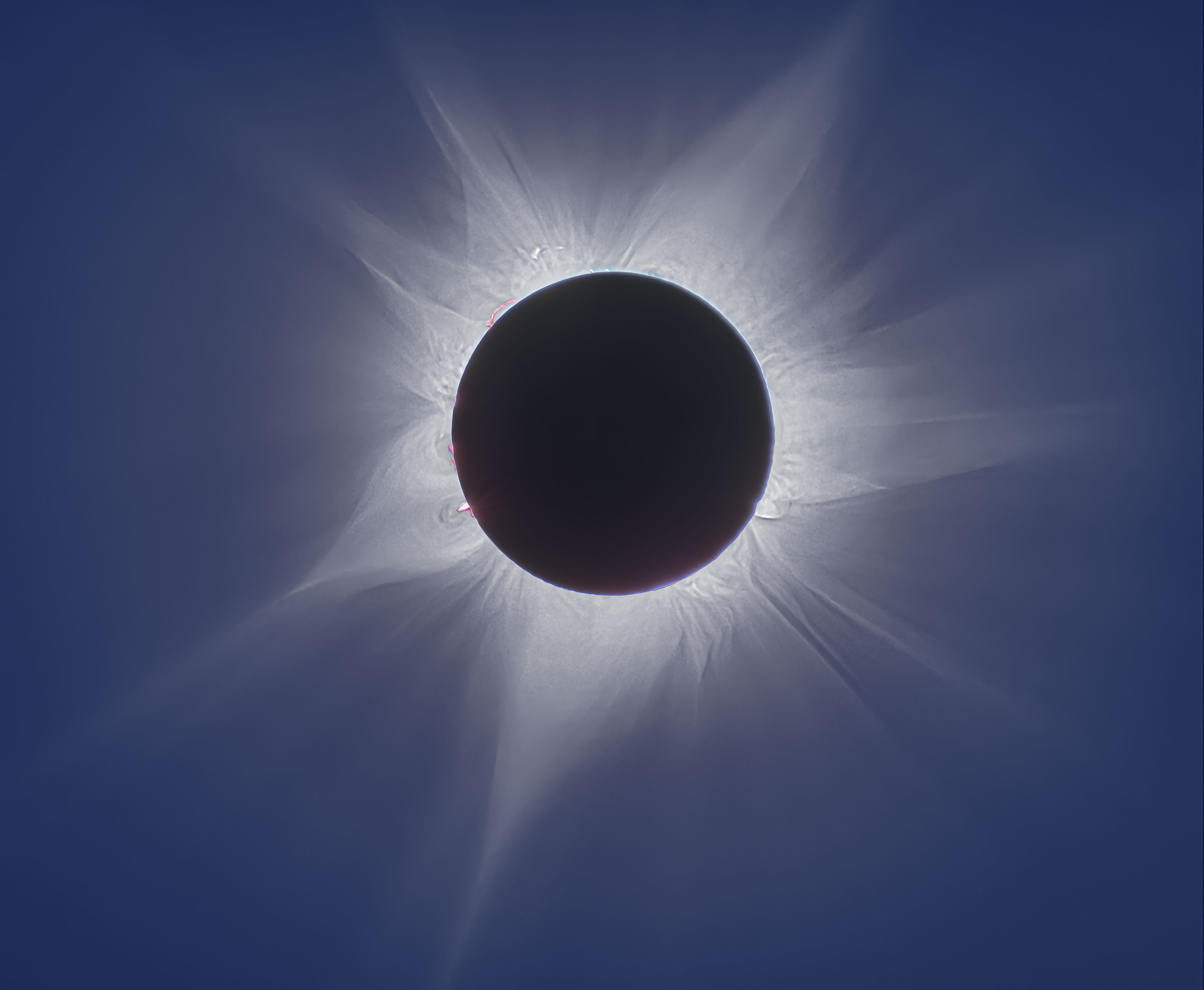 On April 20, 2023 the shadow of a New Moon raced across planet Earth's southern hemisphere. When viewed along a narrow path that mostly avoided landfall, the Moon in silhouette created a hybrid solar eclipse. Hybrid eclipses are rare and can be seen as a total eclipse or an annular "ring of fire" eclipse depending on the observer's position. Viewers of this much anticipated hybrid event were able to witness a total solar eclipse while anchored in the Indian Ocean near the centerline of the eclipse track off the coast of western Australia. This ship-borne image from renowned eclipse chaser Fred Espenak captured the active Sun's magnificent outer atmosphere, or solar corona, streaming into space. The composite of 11 exposures ranging from 1/2000 to 1/2 second, taken during the 62 seconds of totality, records an extended range of brightness to follow alluring details of the corona not quite visible to the eye.  Fred Espenak (1953-2025)