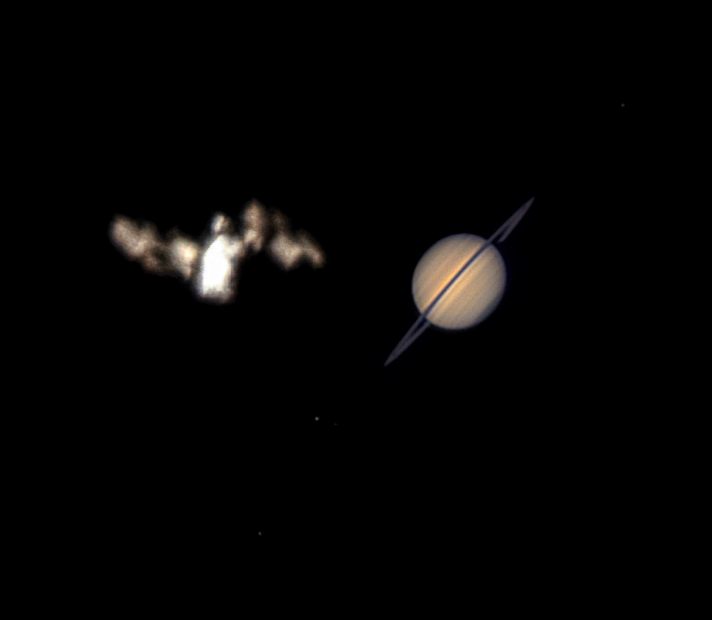 This month, bright planet Saturn rises in evening skies, its rings oriented nearly edge-on when viewed from planet Earth. And in the early morning hours on July 6, it posed very briefly with the International Space Station when viewed from a location in Federal Way, Washington, USA. This well-planned image, a stack of video frames, captures their momentary conjunction in the same telescopic field of view. With the ISS in low Earth orbit, space station and gas giant planet were separated by almost 1.4 billion kilometers. Their apparent sizes are comparable but the ISS was much brighter than Saturn and the ringed planet's brightness has been increased for visibility in the stacked image. Precise timing and an exact location were needed to capture the ISS/Saturn conjunction.