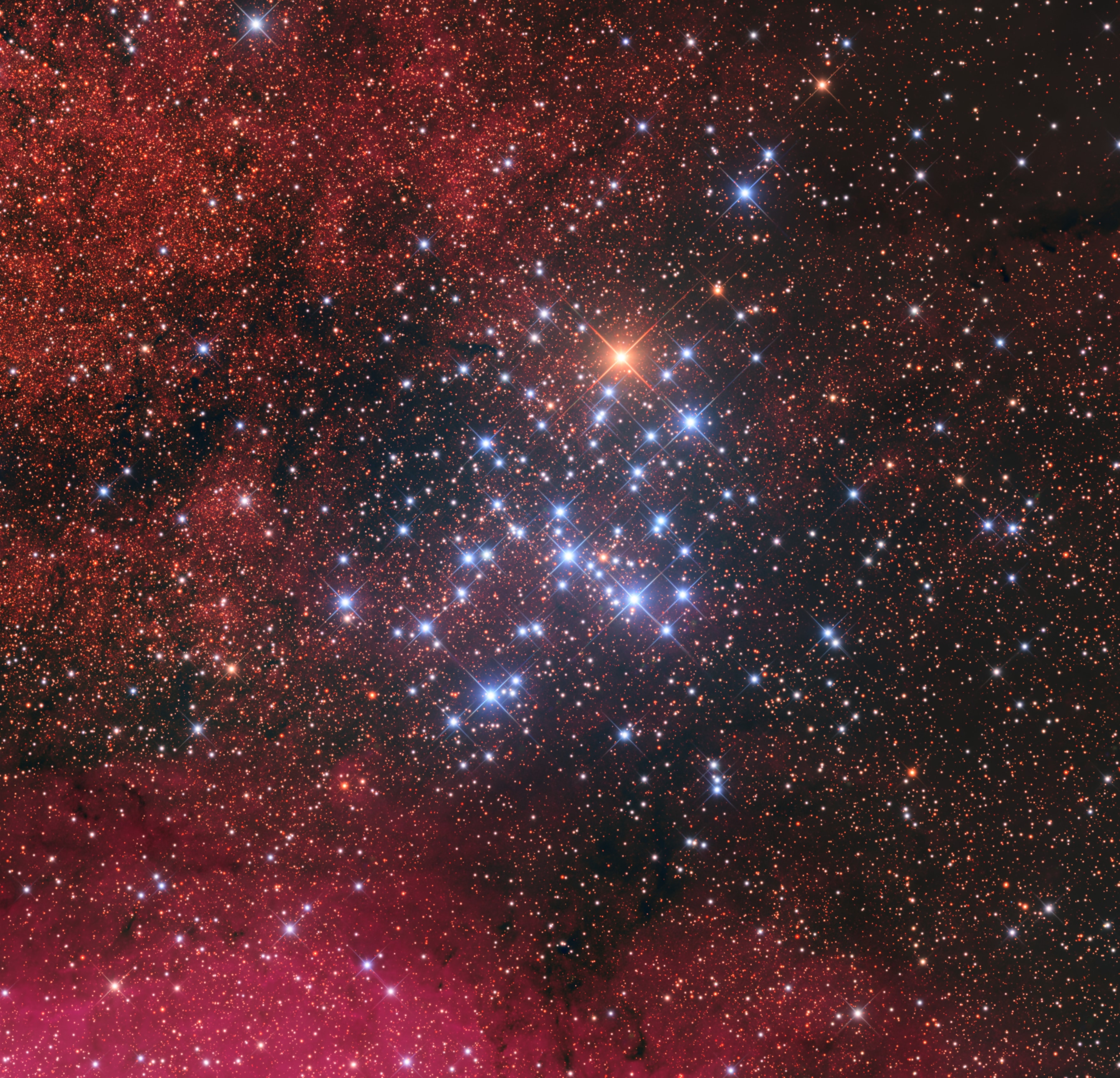 The sixth object in Charles Messier's famous catalog of things which are not comets, Messier 6 is a galactic or open star cluster. A gathering of 100 stars or so, all around 100 million years young, M6 lies some 1,600 light-years away toward the central Milky Way in the constellation Scorpius. Also cataloged as NGC 6405, the pretty star cluster's outline suggests its popular moniker, the Butterfly Cluster. Surrounded by diffuse reddish emission from the region's hydrogen gas the cluster's mostly hot and therefore blue stars are near the center of this colorful cosmic snapshot. But the brightest cluster member is a cool K-type giant star. Designated BM Scorpii it shines with a yellow-orange hue, seen near the end of one of the butterfly's antennae. This telescopic field of view spans nearly 2 Full Moons on the sky. That's 25 light-years at the estimated distance of Messier 6.