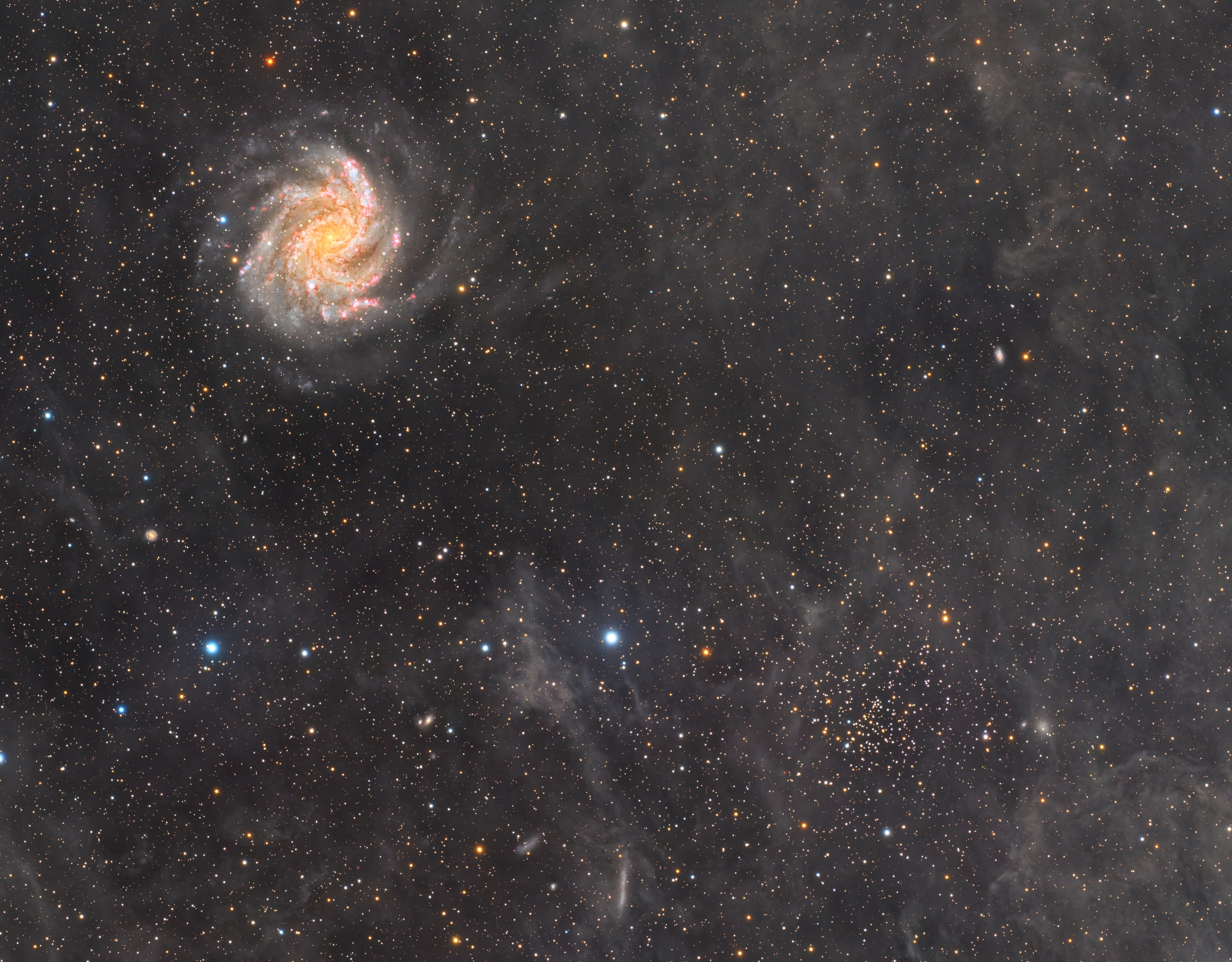 Face-on spiral galaxy NGC 6946 and open star cluster NGC 6939 share this cosmic snapshot, composed with over 68 hours of image data captured with a small telescope on planet Earth. The field of view spans spans about 1 degree or 2 full moons on the sky toward the northern constellation Cepheus. Seen through faint interstellar dust couds near the plane of our Milky Way galaxy, the stars of open cluster NGC 6939 are 5,600 light-years in the distance, near bottom right in the frame. Face-on spiral galaxy NGC 6946 is at top left, but lies some 22 million light-years away. In the last 100 years, 10 supernovae have been discovered in NGC 6946, the latest one seen in 2017. By comparison, the average rate of supernovae in our Milky Way is about 1 every 100 years or so. Of course, NGC 6946 is also known as The Fireworks Galaxy.