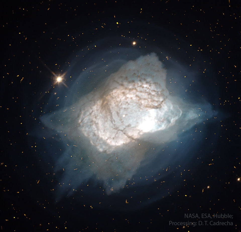 What created this unusual planetary nebula? Dubbed the Pillow Nebula and the Flying Carpet Nebula, NGC 7027 is one of the smallest, brightest, and most unusually shaped planetary nebulas known. Given its expansion rate, NGC 7027 first started expanding, as visible from Earth, about 600 years ago.  For much of its history, the planetary nebula has been expelling shells, as seen in blue in the featured image by the Hubble Space Telescope.  In modern times, though, for reasons unknown, it began ejecting gas and dust (seen in brown) in specific directions that created a new pattern that seems to have four corners. What lies at the nebula's center is unknown, with one hypothesis holding it to be a close binary star system where one star sheds gas onto an erratic disk orbiting the other star. NGC 7027, about 3,000 light years away, was first discovered in 1878 and can be seen with a standard backyard telescope toward the constellation of the Swan (Cygnus).