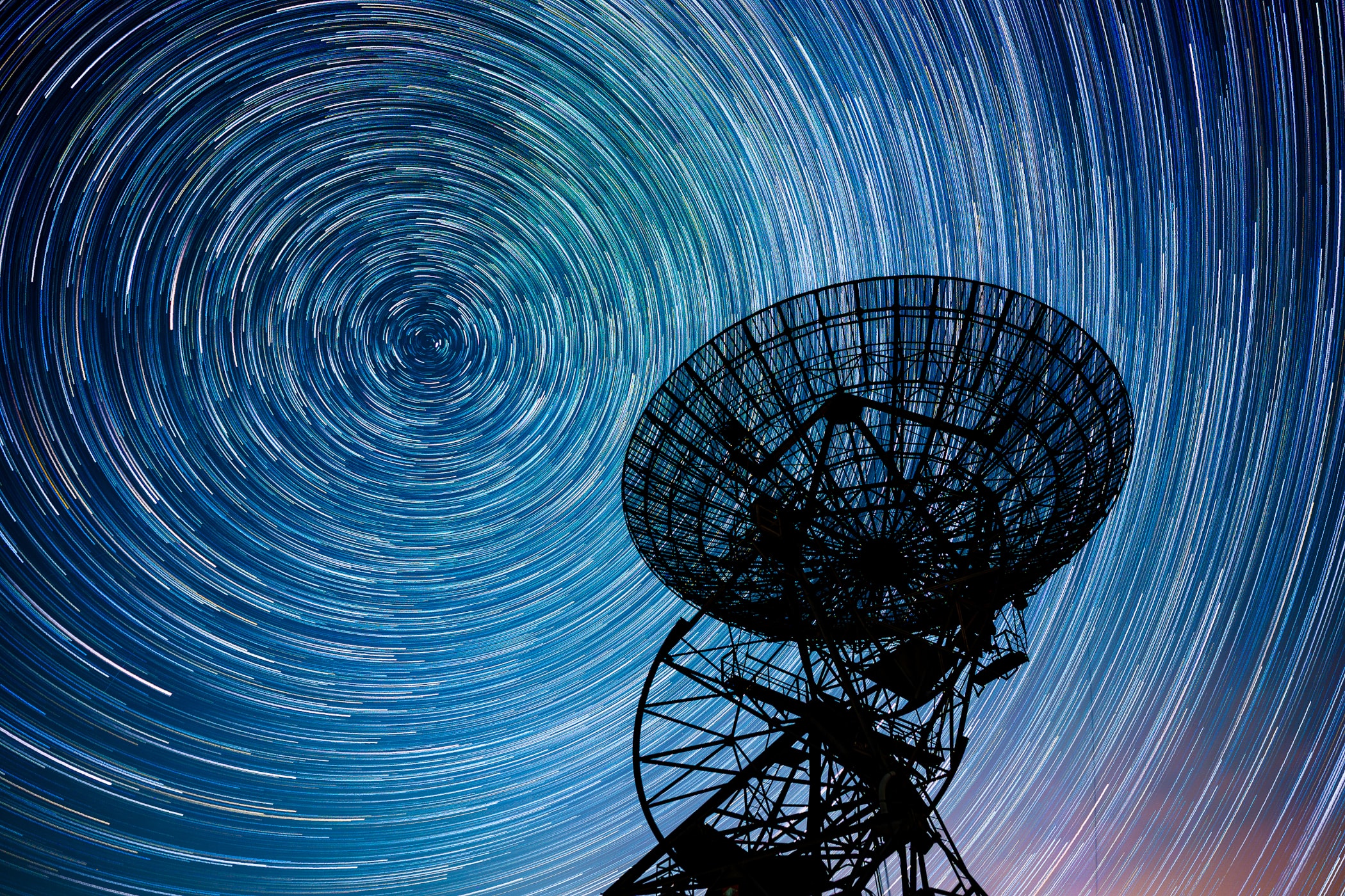 The steerable 60 foot diameter dish antenna of the One-Mile Telescope at Mullard Radio Astronomy Observatory, Cambridge, UK, is pointing skyward in this evocative night-skyscape. To capture the dramatic scene, consecutive 30 second exposures were recorded over a period of 90 minutes. Combined, the exposures reveal a background of gracefully arcing star trails that reflect planet Earth's daily rotation on its axis. The North Celestial Pole, the extension of Earth's axis of rotation into space, points near Polaris, the North Star. That's the bright star that creates the short trail near the center of the concentric arcs. But the historic One-Mile Telescope array also relied on planet Earth's rotation to operate. Exploring the universe at radio wavelengths, it was the first radio telescope to use Earth-rotation aperture synthesis. That technique uses the rotation of the Earth to change the relative orientation of the telescope array and celestial radio sources to create radio maps of the sky at a resolution better than that of the human eye.