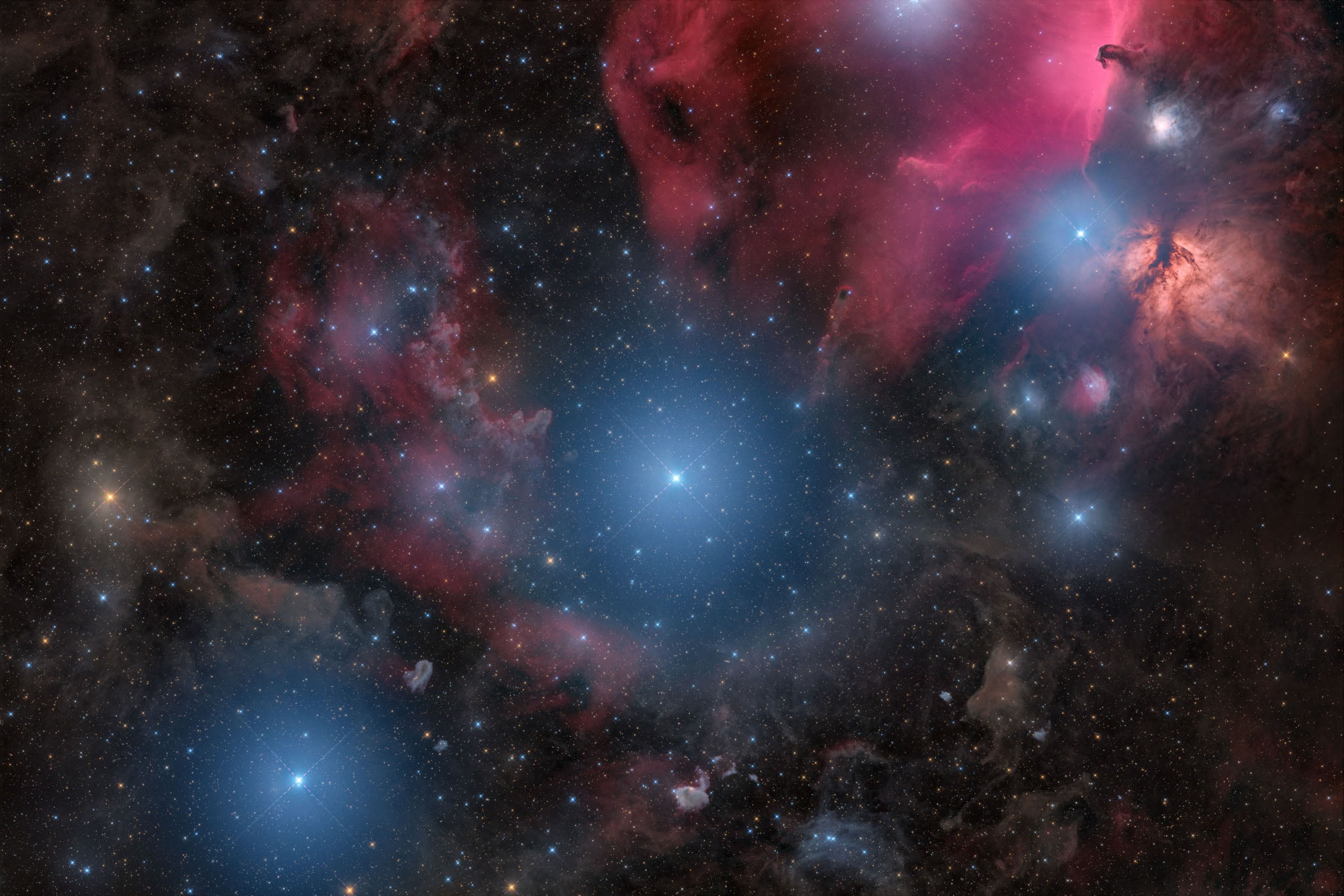 Alnitak, Alnilam, and Mintaka are the bright bluish stars from east to west (upper right to lower left) along the diagonal in this cosmic vista. Otherwise known as the Belt of Orion, these three blue supergiant stars are hotter and much more massive than the Sun. They lie from 700 to 2,000 light-years away, born of Orion's well-studied interstellar clouds. In fact, clouds of gas and dust adrift in this region have some surprisingly familiar shapes, including the dark Horsehead Nebula and Flame Nebula near Alnitak at the upper right. The famous Orion Nebula itself is off the right edge of this colorful starfield. The telescopic frame spans almost 4 degrees on the sky.