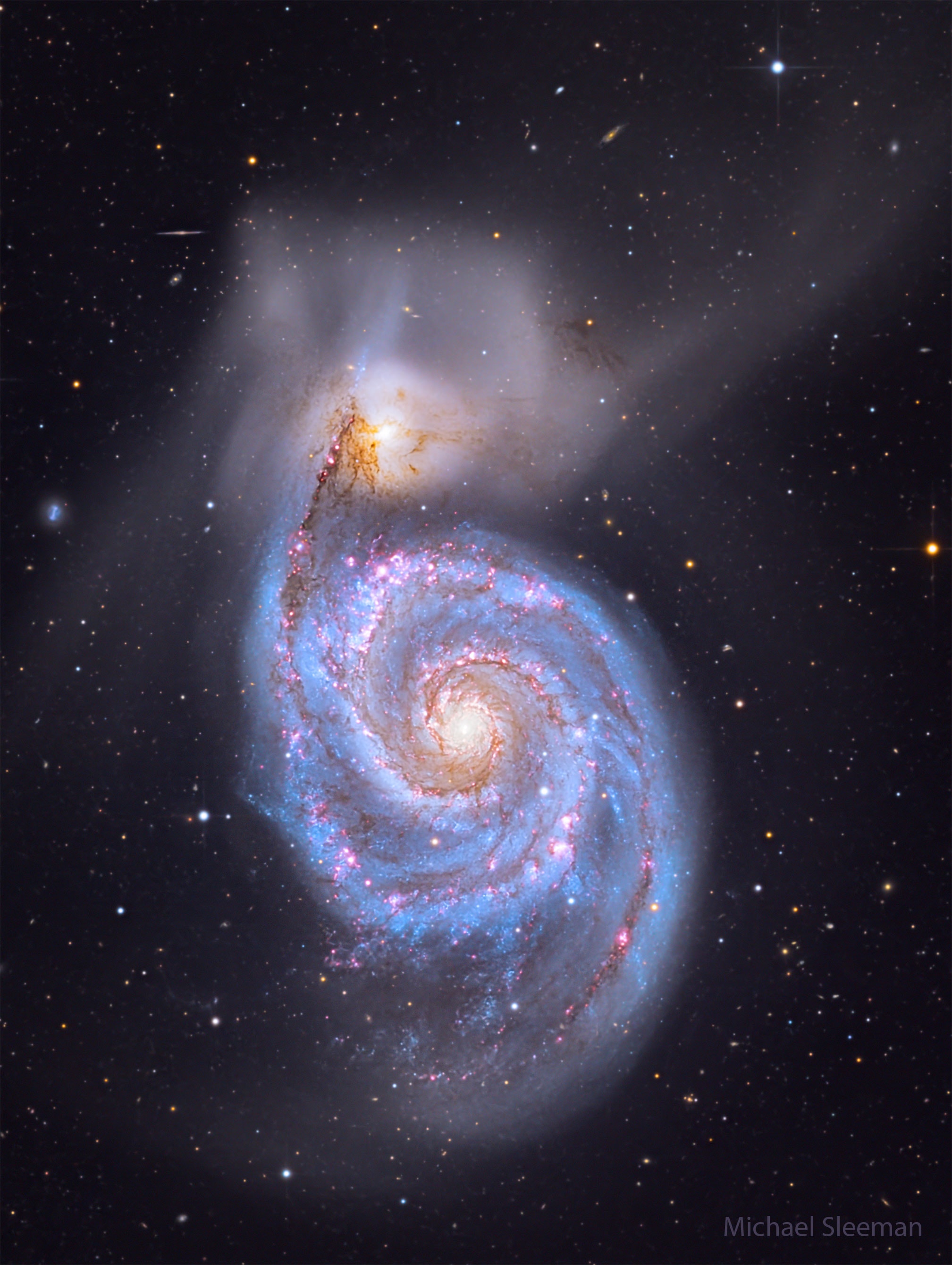 The Whirlpool Galaxy is a classic spiral galaxy. At only 30 million light years distant and fully 60 thousand light years across, M51, also known as NGC 5194, is one of the brightest and most picturesque galaxies on the sky.  The featured deep image is a digital combination of images taken in different colors over 58 hours with a telescope from Lijiang, China. Anyone with a good pair of binoculars, however, can see this Whirlpool toward the constellation of the Hunting Dogs (Canes Venatici). M51 is a spiral galaxy of type Sc and is the dominant member of a whole group of galaxies.  Astronomers speculate that M51's spiral structure is primarily due to its gravitational interaction with the smaller galaxy just above it.