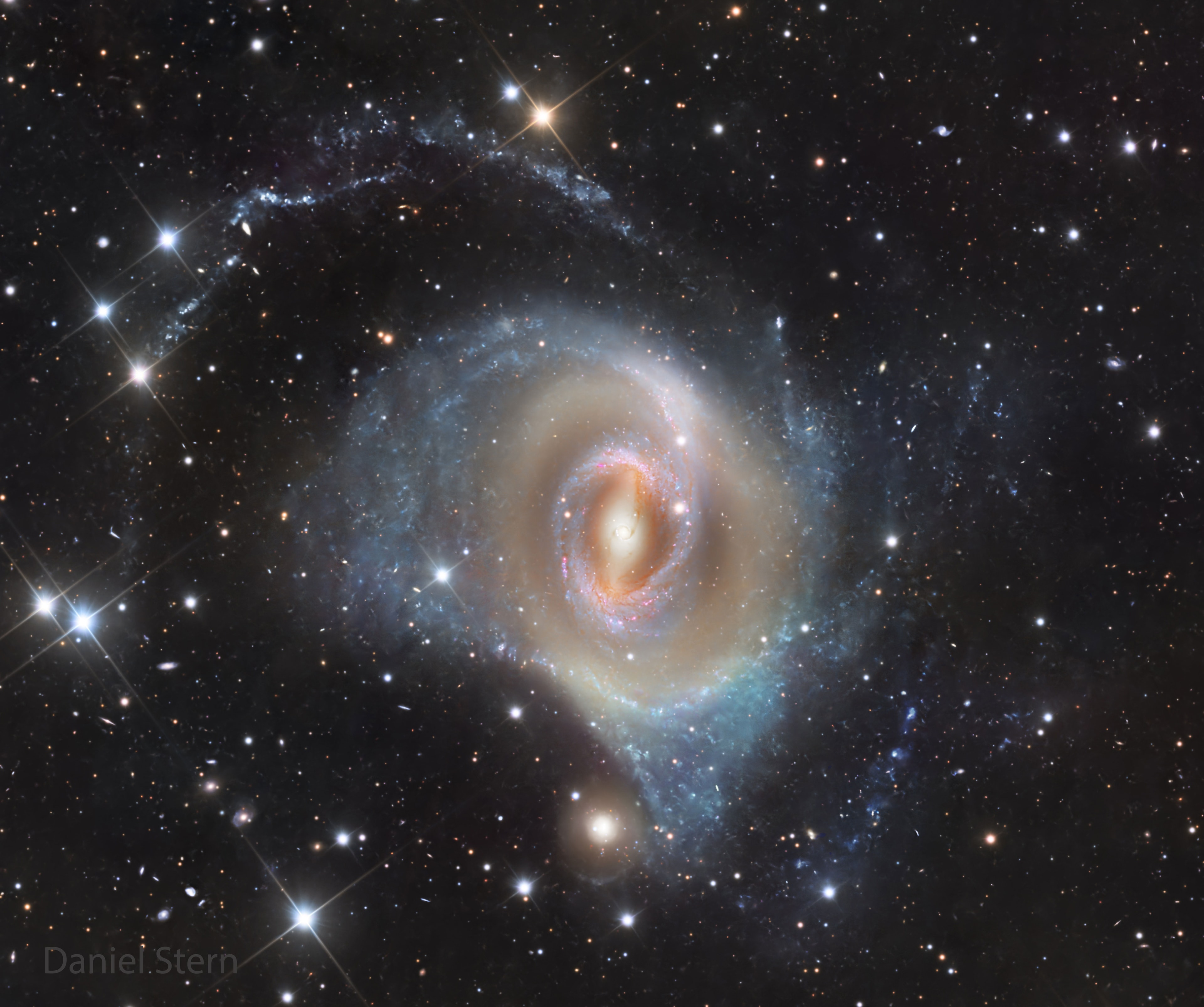 Most galaxies don't have any rings -- why does this galaxy have three?  To begin, a ring that's near NGC 1512's center -- and so hard to see here -- is the nuclear ring which glows brightly with recently formed stars.  Next out is a ring of stars and dust appearing both red and blue, called, counter-intuitively, the inner ring.  This inner ring connects ends of a diffuse central bar of stars that runs horizontally across the galaxy.  Farthest out in this wide field image is a ragged structure that might be considered an outer ring. This outer ring appears spiral-like and is dotted with clusters of bright blue stars.  All these ring structures are thought to be affected by NGC 1512's own gravitational asymmetries in a drawn-out process called secular evolution.  The featured image was captured last month from a telescope at Deep Sky Chile in Chile.