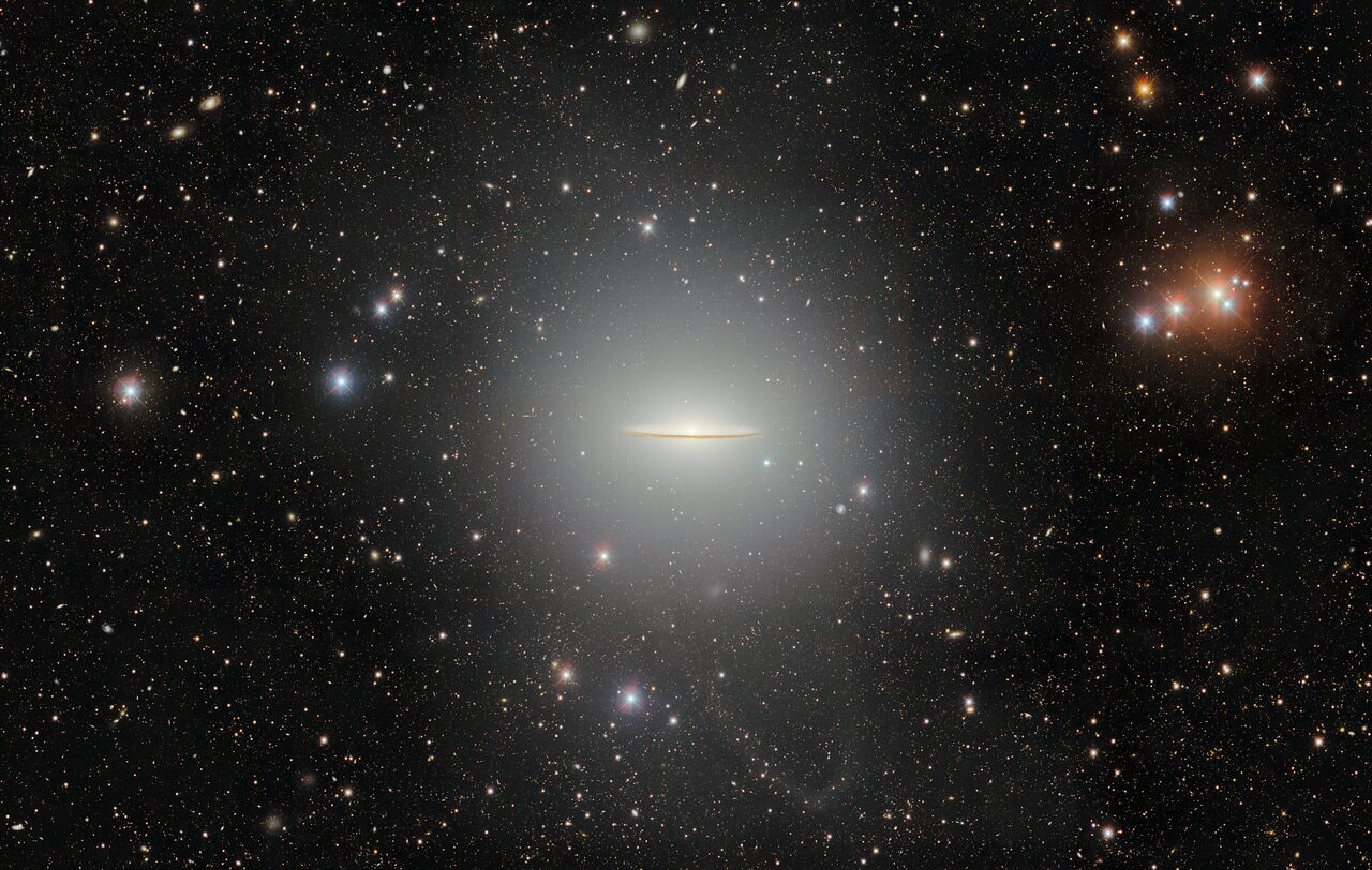A gorgeous spiral galaxy, Messier 104 is famous for its nearly edge-on profile featuring a broad ring of obscuring dust lanes. Seen in silhouette against an extensive central bulge of stars, the swath of cosmic dust lends a broad brimmed hat-like appearance to the galaxy suggesting a more popular moniker, the Sombrero Galaxy. Also known as NGC 4594, the Sombrero galaxy can be seen across the spectrum and is host to a central supermassive black hole. About 50,000 light-years across and 28 million light-years away, M104 is one of the largest galaxies at the southern edge of the Virgo Galaxy Cluster. Still, the spiky foreground stars in this field of view lie well within our own Milky Way. This broad view of the well-known galaxy was processed to reveal M104's extended halo, as well as a faint tidal stellar stream. It was captured by the Dark Energy Camera (DECam) on the Blanco 4-meter telescope at the Cerro Tololo Inter-American Observatory.