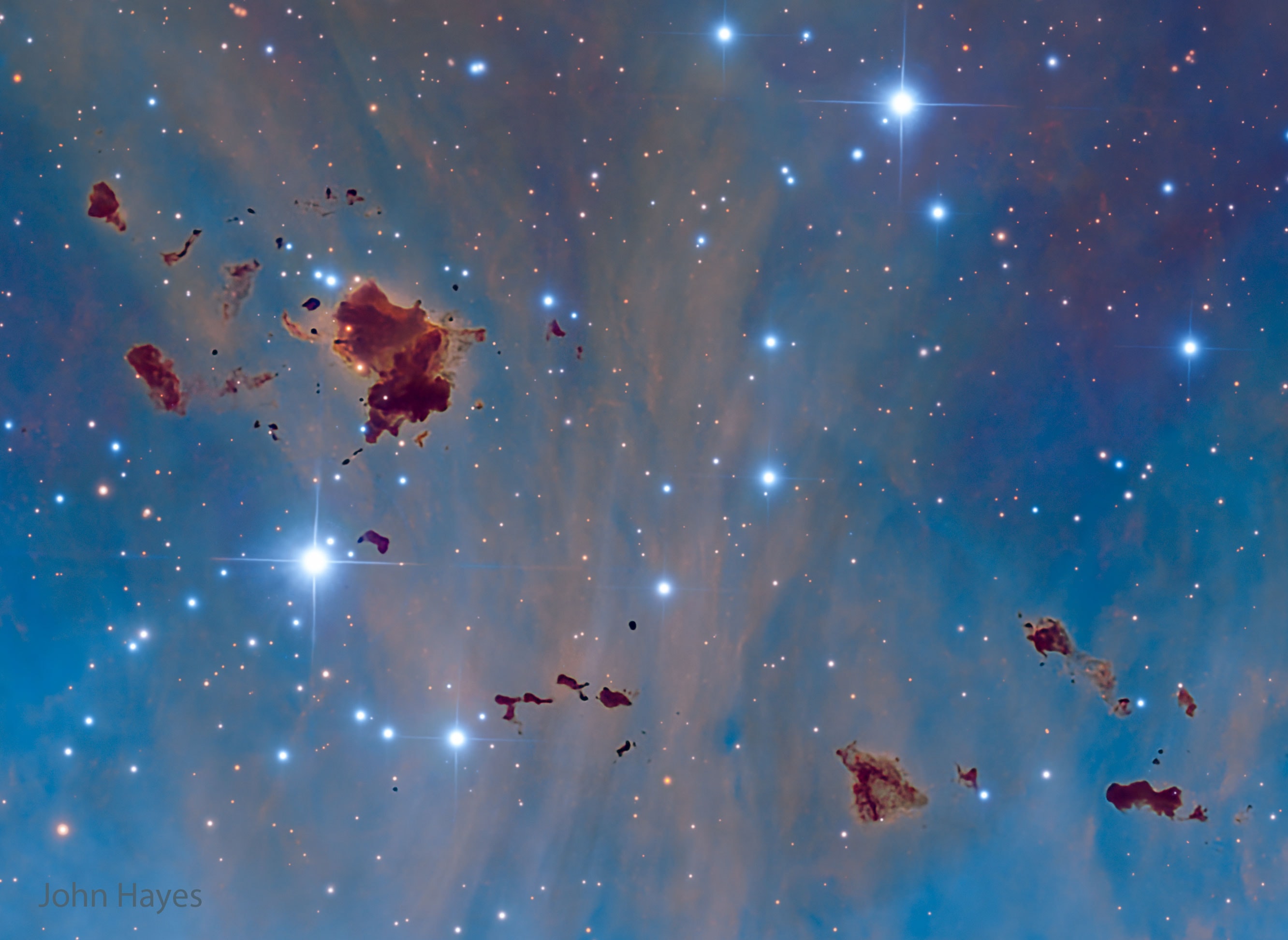 What are these strange space globs?  Situated in rich star fields and glowing hydrogen gas, these opaque clouds of interstellar dust and gas are so large they might be able to form stars. Their home is known as IC 2944, a bright stellar nursery located about 7,600 light years away toward the constellation of the Centaur (Centaurus). The largest of these  dark globules, first spotted by A. D. Thackeray in 1950 using a telescope in South Africa, is likely two separate but overlapping clouds, each more than one light-year wide. Along with other data, the featured Hubble palette image from the El Sauce Observatory in Chile, indicates that Thackeray's globules are fractured and churning as a result of intense ultraviolet radiation from young, hot stars already energizing and heating the bright emission nebula. These and similar dark globules known to be associated with other star forming regions may ultimately be dissipated by their hostile environment -- like cosmic lumps of butter in a hot frying pan.   Interstellar Jigsaw: Astronomy Puzzle of the Day