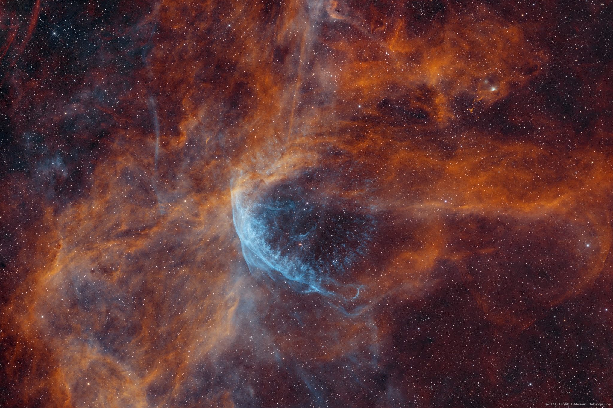 This cosmic snapshot covers a field of view over twice as wide as the full Moon within the boundaries of the high-flying constellation Cygnus. Made using astronomical narrowband filters, the image highlights the bright edge of a ring-like nebula traced by the glow of ionized hydrogen and oxygen gas. Embedded in the region's expanse of interstellar clouds, the complex, glowing arcs are sections of shells of material swept up by the wind from Wolf-Rayet star WR 134, the brightest star near image center. Distance estimates put WR 134 about 6,000 light-years away, making this telescopic frame over 100 light-years across. Shedding their outer envelopes in powerful stellar winds, massive Wolf-Rayet stars have burned through their nuclear fuel at a prodigious rate and end their final phase of massive star evolution in a spectacular supernova. Their stellar winds and final supernova explosion enrich the interstellar material with heavy elements to be incorporated in future generations of stars.