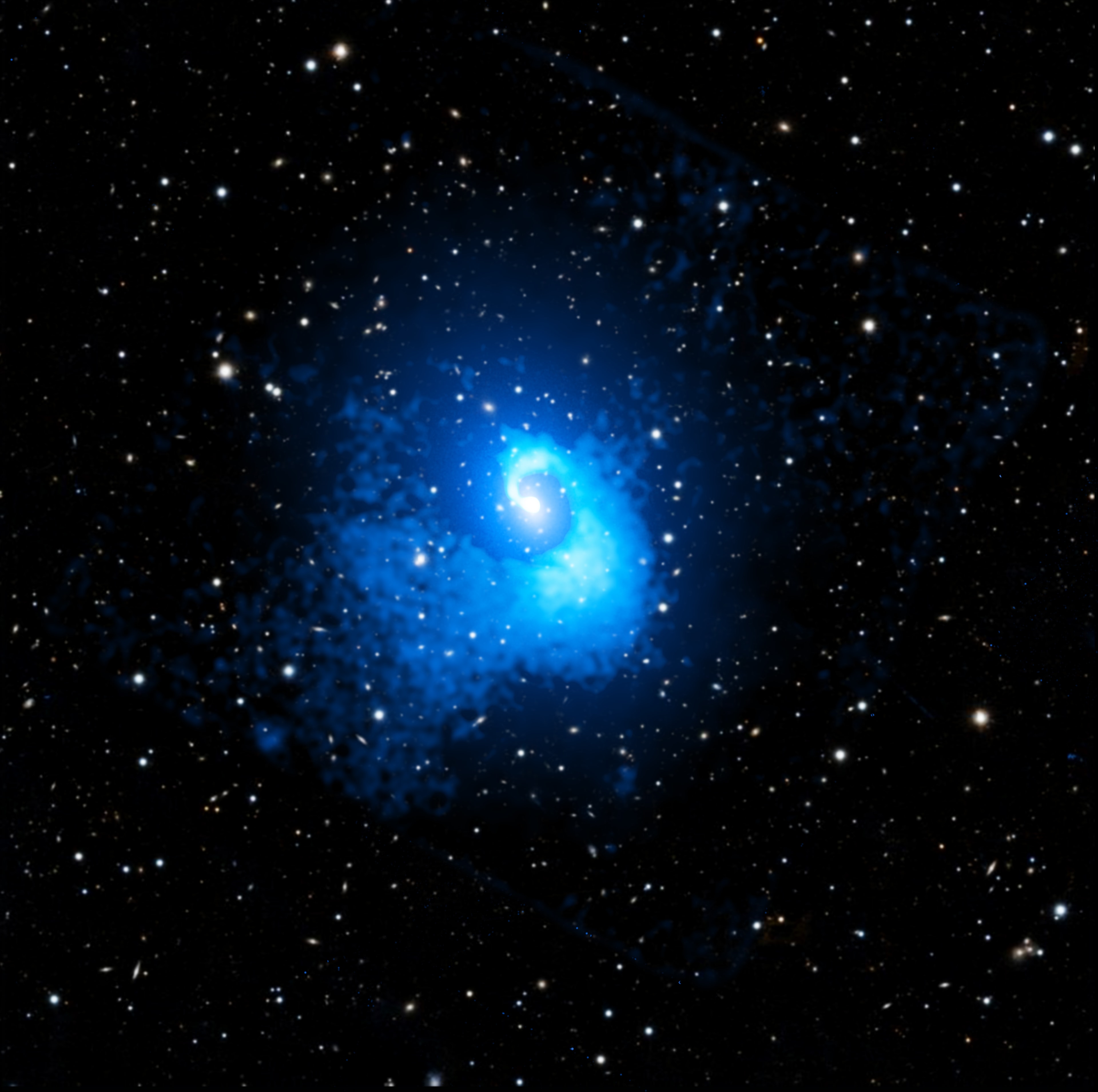 This big beautiful spiral shines in X-ray light. It is about 20 times larger than our Galaxy.   It belongs to Abell 2029, a galaxy cluster one billion light-years away.   (To see only the galaxies, hover your cursor over the image, or follow this link.)      Galaxy clusters are the largest structures in the universe that are supported by gravity.     Abell 2029 is formed by thousands of galaxies, surrounded by a huge cloud of hot gas and the equivalent of hundreds of trillions times the mass of the Sun in dark matter.     The spiral is made of gas, mostly hydrogen and helium, heated to tens of millions of degrees.     It was found in a recent study that used data from NASA's Chandra X-ray Observatory to show that Abell 2029 had a collision with a smaller cluster four billion years ago.     The collision affected the gravitational field and caused the intracluster gas to slosh, like wine moving in a wine glass, shaping the spiral.