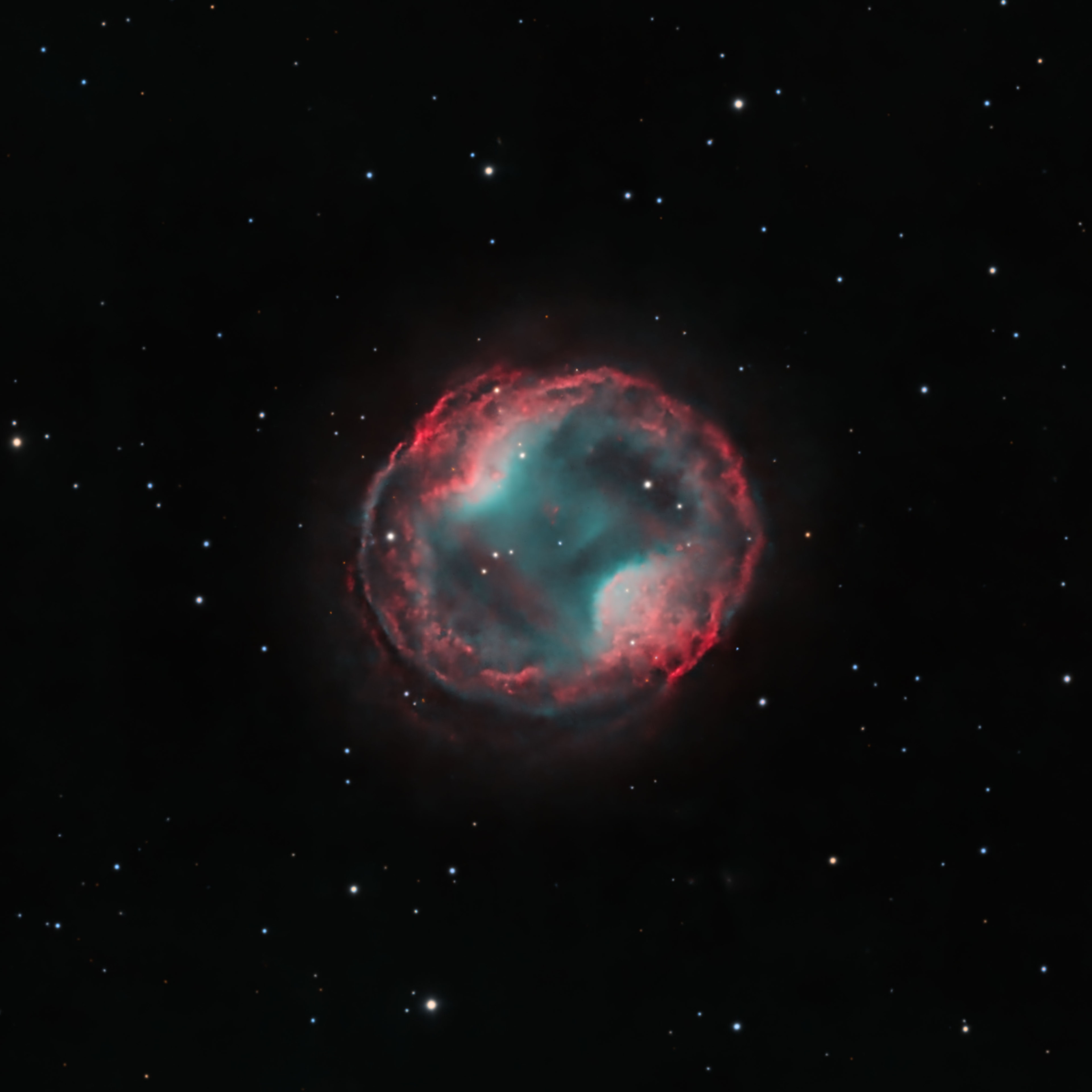 What is a pair of headphones doing in the sky? Today’s image features the Headphone Nebula, also known as PK 164 +31.1 or Jones-Emberson 1. This planetary nebula, the remnant of a dying Sun-like star, faintly occupies an angular region of the Lynx constellation about 1/5th the diameter of the full moon. The red and blue-ish green colors trace hydrogen and oxygen atoms, respectively, that have been excited and ionized by the nebula's central white dwarf. The headphone shape, where two lobes of hydrogen puncture the inner region of oxygen, adds this object to a long list of oddly shaped nebulae. The morphology of such strange nebulae hint at the presence of a stellar or planetary companion, which can stir the material flowing out from the dying star. You can listen to Hubble and JWST sonifications of planetary nebulae through your very own headphones!