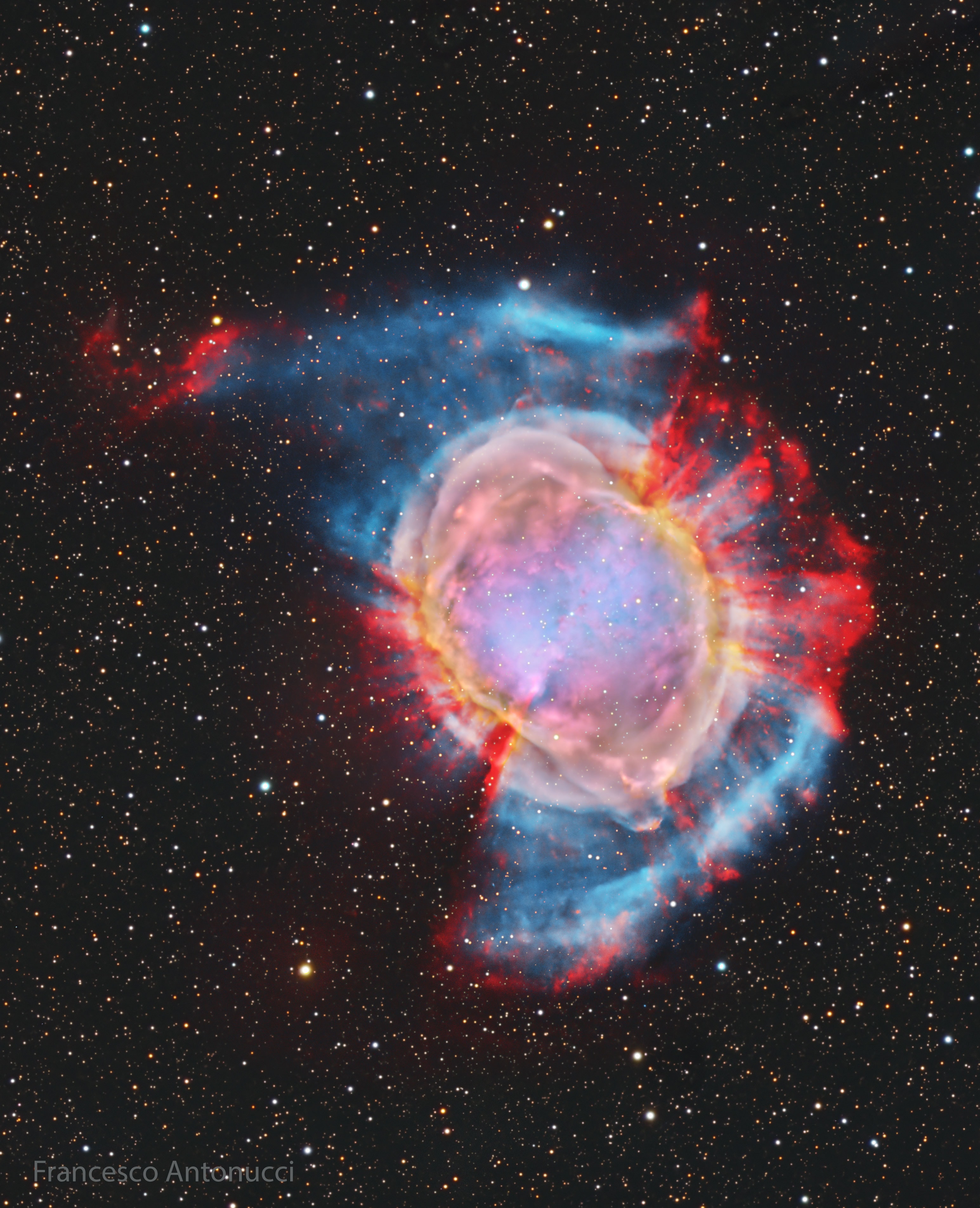 Is this what will become of our Sun? Quite possibly.  The first hint of our Sun's future was discovered inadvertently in 1764. At that time, Charles Messier was compiling a list of diffuse objects not to be confused with comets. The 27th object on Messier's list, now known as M27 or the Dumbbell Nebula, is a planetary nebula, one of the brightest planetary nebulas on the sky and visible with binoculars toward the constellation of the Fox (Vulpecula). It takes light about 1000 years to reach us from M27, featured here in colors enhanced by red for  hydrogen and blue for oxygen. We now know that in about 6 billion years, our Sun will shed its outer gases into a planetary nebula like M27, while its remaining center will become an X-ray hot white dwarf star.  Understanding the physics and significance of M27 was well beyond 18th century science, though. Even today, many things remain mysterious about planetary nebulas, including how their intricate shapes are created.