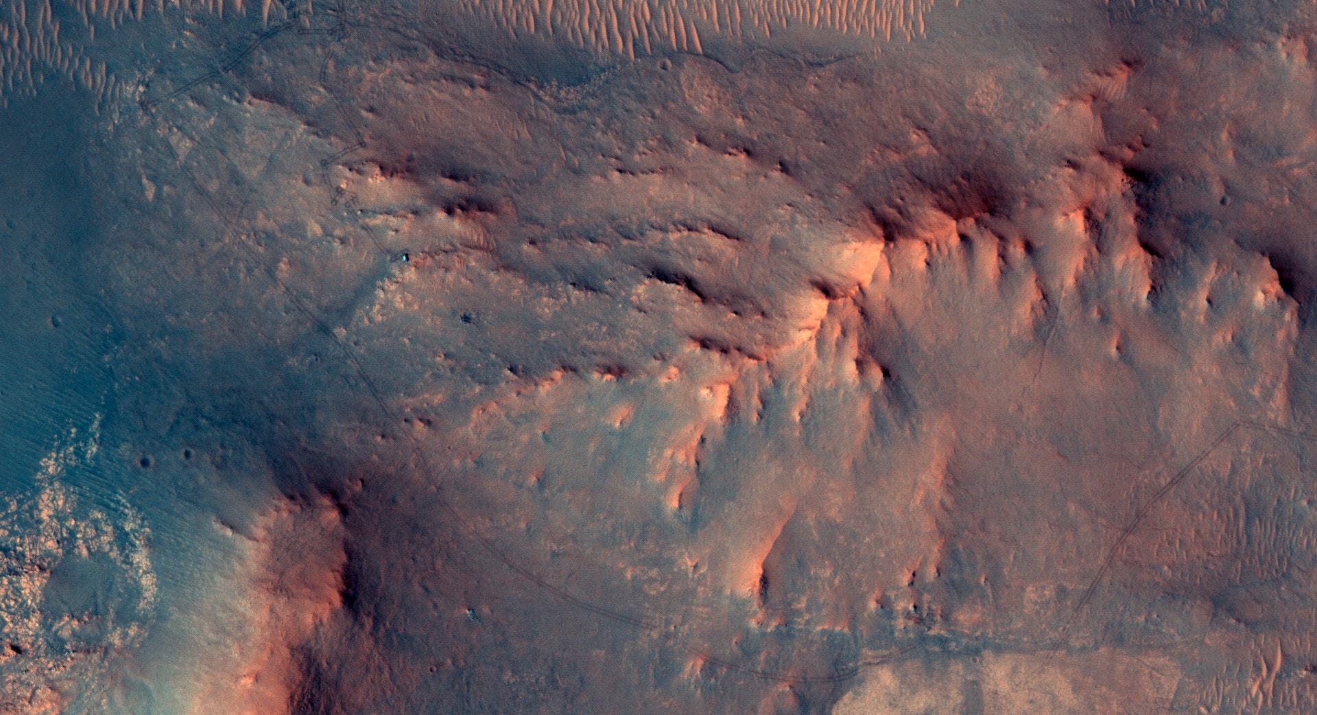 In this recent HiRISE view from the Mars Reconnaissance Orbiter, the little green dot indicated on the surface of the big Red Planet is the Perseverance Mars rover. Recorded on June 13, the car-sized, six-wheeled robot was imaged a day before completing a Martian marathon, traveling a total distance of 26.218 miles (42.195 kilometers) since it began exploring the surface of Mars. That equivalent marathon distance was achieved by Perseverance on its mission sol (Martian day) 1,890, after about 5 Earth years and 4 Earth months of driving. Perseverance is continuing to hunt for biosignatures. In the HiRISE image, the Mars rover's tracks can be seen leading to its location in an area west of its landing site in Jezero crater near an ancient river delta.