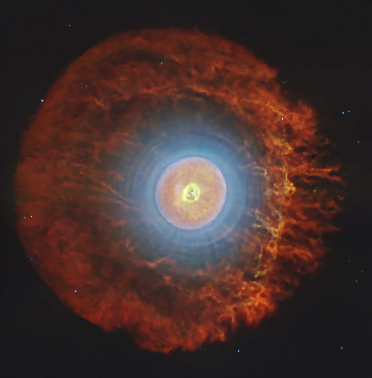 What is happening inside this unusual nebula?   Planetary nebula Tc 1, captured here in exquisite detail by the James Webb Space Telescope, is the celestial site where buckyballs were first identified in 2010.     Buckminsterfullerene — as buckyballs are officially called — is a molecule with 60 carbon atoms (C60) arranged in the shape of a soccer ball.   The molecule is named for architect Buckminster Fuller because of its resemblance to the geodesic dome he helped popularize.   Webb’s new data reveal where the C60 molecules live in this nebula, and the geometry is striking: they populate a thin spherical shell around the central star, visible here as the bright edge of the nebula’s glowing orange central region.   Look closely near the nebula’s heart and a more perplexing feature emerges: a delicate structure shaped uncannily like an upside-down question mark, fitting punctuation for the many questions this nebula still poses.