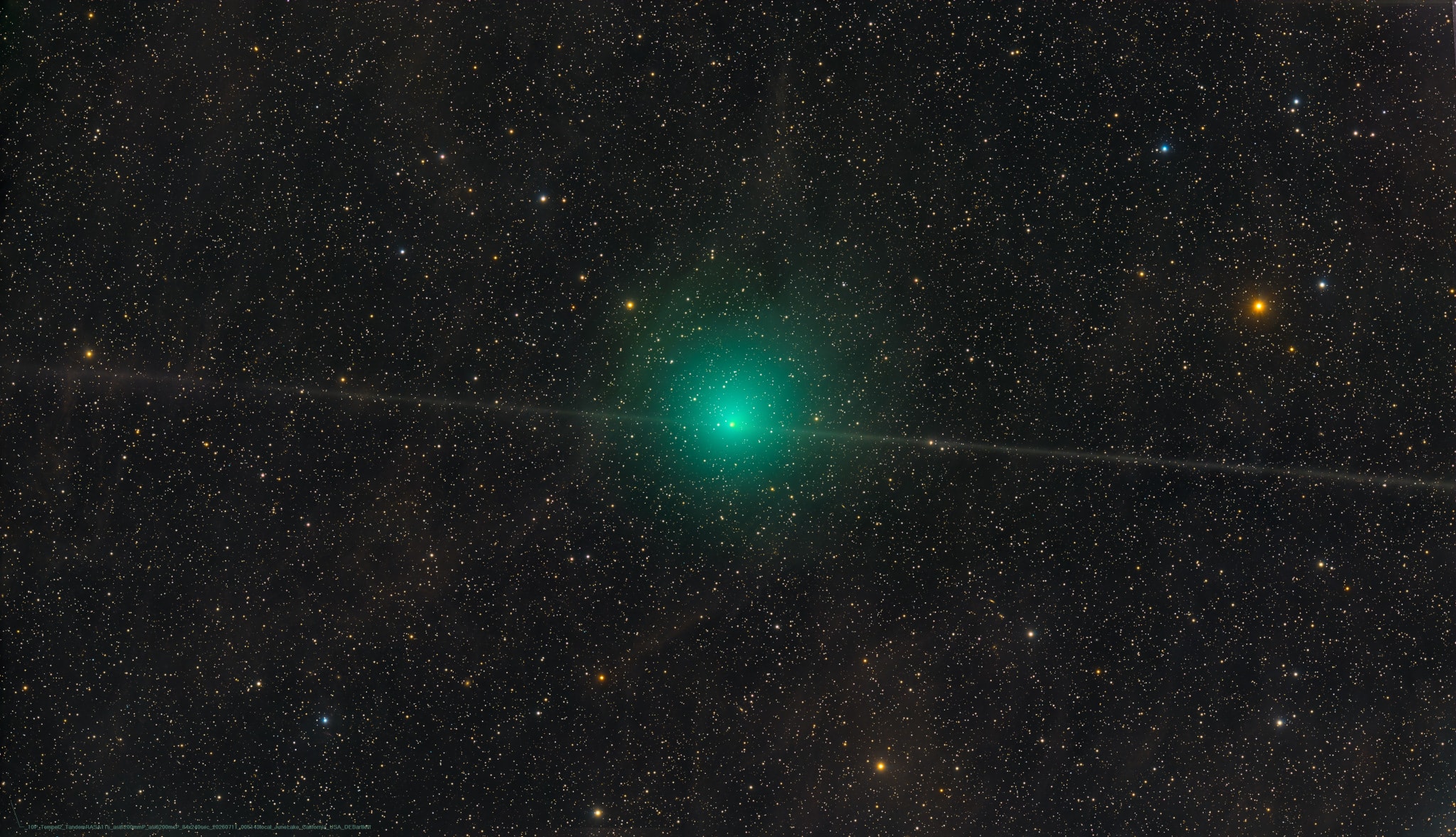 Comet 10P/Tempel 2 orbits the Sun once every 5.4 years. Currently visible in binoculars or small telescopes toward the constellation Capricornus, the periodic comet is captured in this sharp telescopic image from July 11 sporting a bright nuclear region and pretty greenish coma. Remarkably, a thin dust trail, not a typical dust tail, is also seen extending both east and west of the Tempel 2 nucleus. Unlike a comet dust tail, which tends to temporarily fan out in a direction away from the Sun, this dust trail is due to the residual dust shed during many past orbits along this ancient periodic comet's orbital plane. In fact, Tempel 2's dust trail may get a little narrower and brighter from our perspective as Earth crosses through the comet's orbital plane on July 20. Comet 10P/Tempel 2 will reach a perihelion on August 2, and make its closest approach to Earth on August 3.