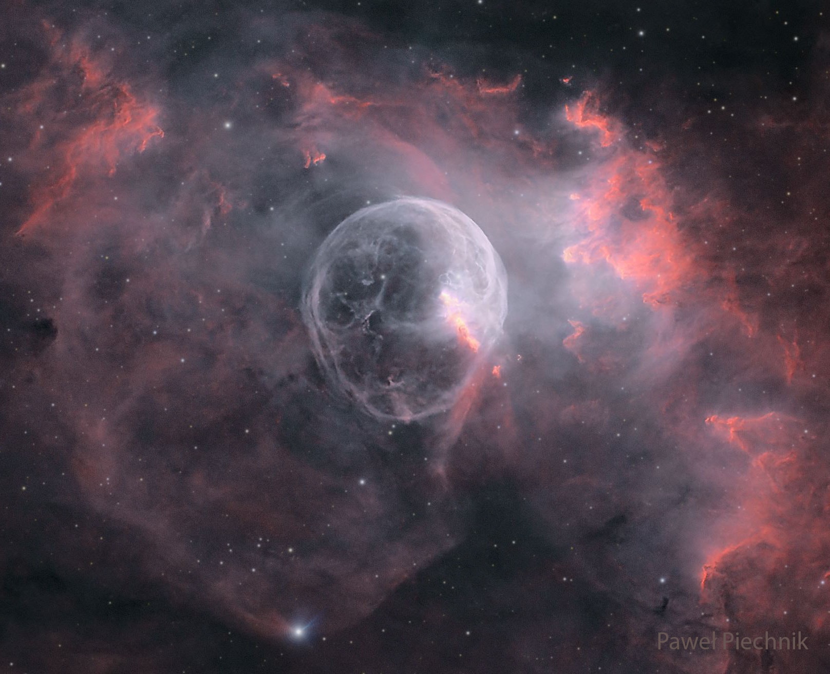 What created this huge space bubble? Blown by the wind from a star, this tantalizing, head-like apparition is cataloged as NGC 7635, but known simply as the Bubble Nebula. Taken from Krakow, Poland, the featured view utilizes a long exposure to reveal the intricate details of this cosmic bubble and its environment. Although it looks delicate, the 10 light-year diameter bubble offers evidence of violent processes at work. Seen here right of the Bubble's center, a bright hot star is embedded in the nebula's reflecting dust. A fierce stellar wind and intense radiation from the star, which likely has a mass 10 to 20 times that of the Sun, has blasted out the structure of glowing gas against denser material in a surrounding molecular cloud. The intriguing Bubble Nebula lies a mere 11,000 light-years away toward the boastful constellation Cassiopeia.