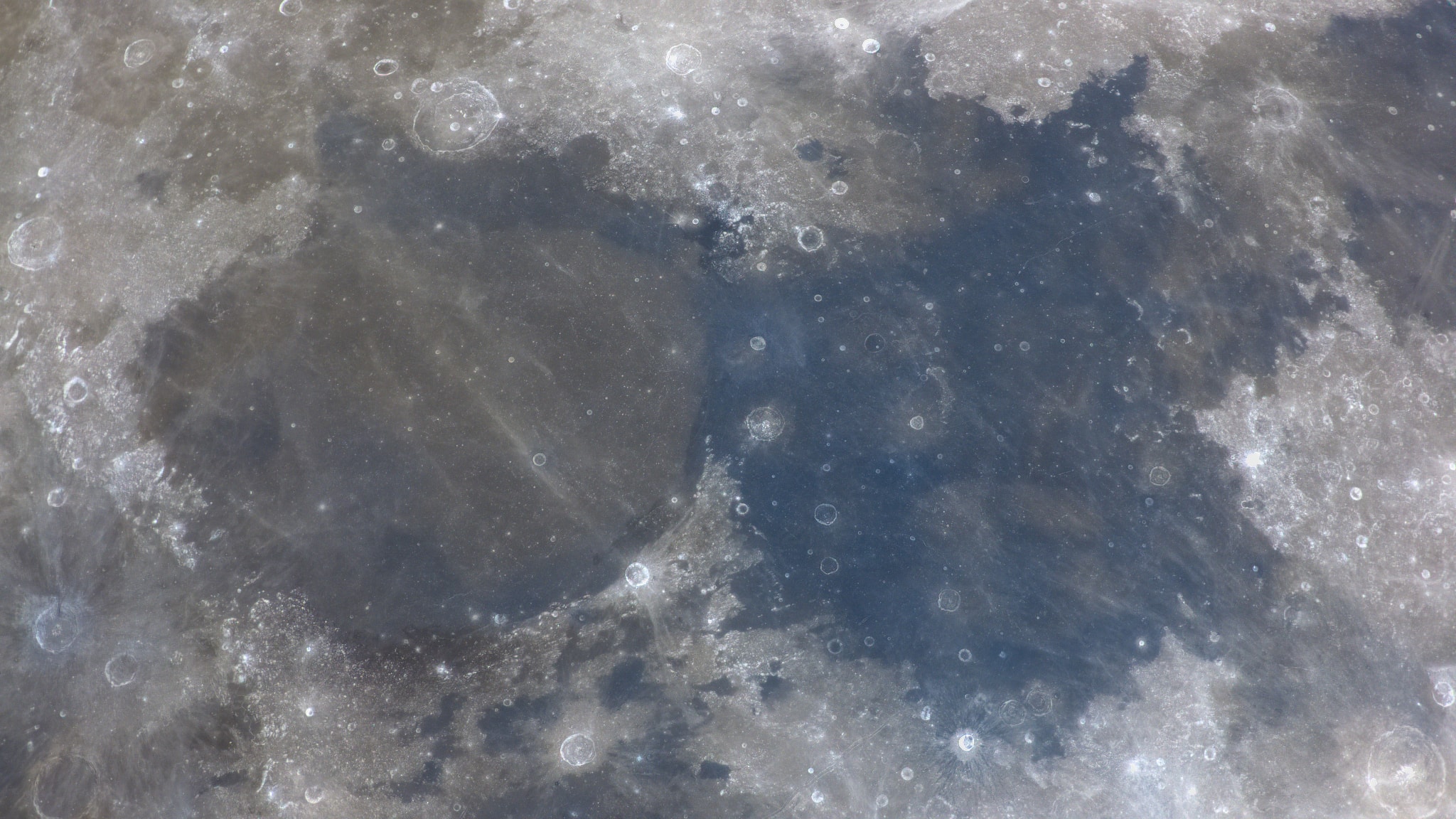 The Seas of Tranquility and Serenity are calm today. They're calm most every day though, since they are actually lunar maria, ancient lava flows filling in large impact basins on the Moon. Also known by Latin names Mare Tranquillitatis (right) and Mare Serenitatis, the smooth dark lunar "seas" are in stark contrast to the bright cratered lunar highlands surrounding them in this telescopic view. Of course their names are based on the historical, pre-telescopic designations of lunar maria. Easily visible to the unaided eye, the broad features on the Moon's near side were imagined to be like the expansive oceans of planet Earth. On July 20, 1969, the Apollo 11 lunar module Eagle touched down on the Mare Tranquillitatis (at lower right), establishing Tranquility base and the first human presence on the Moon.