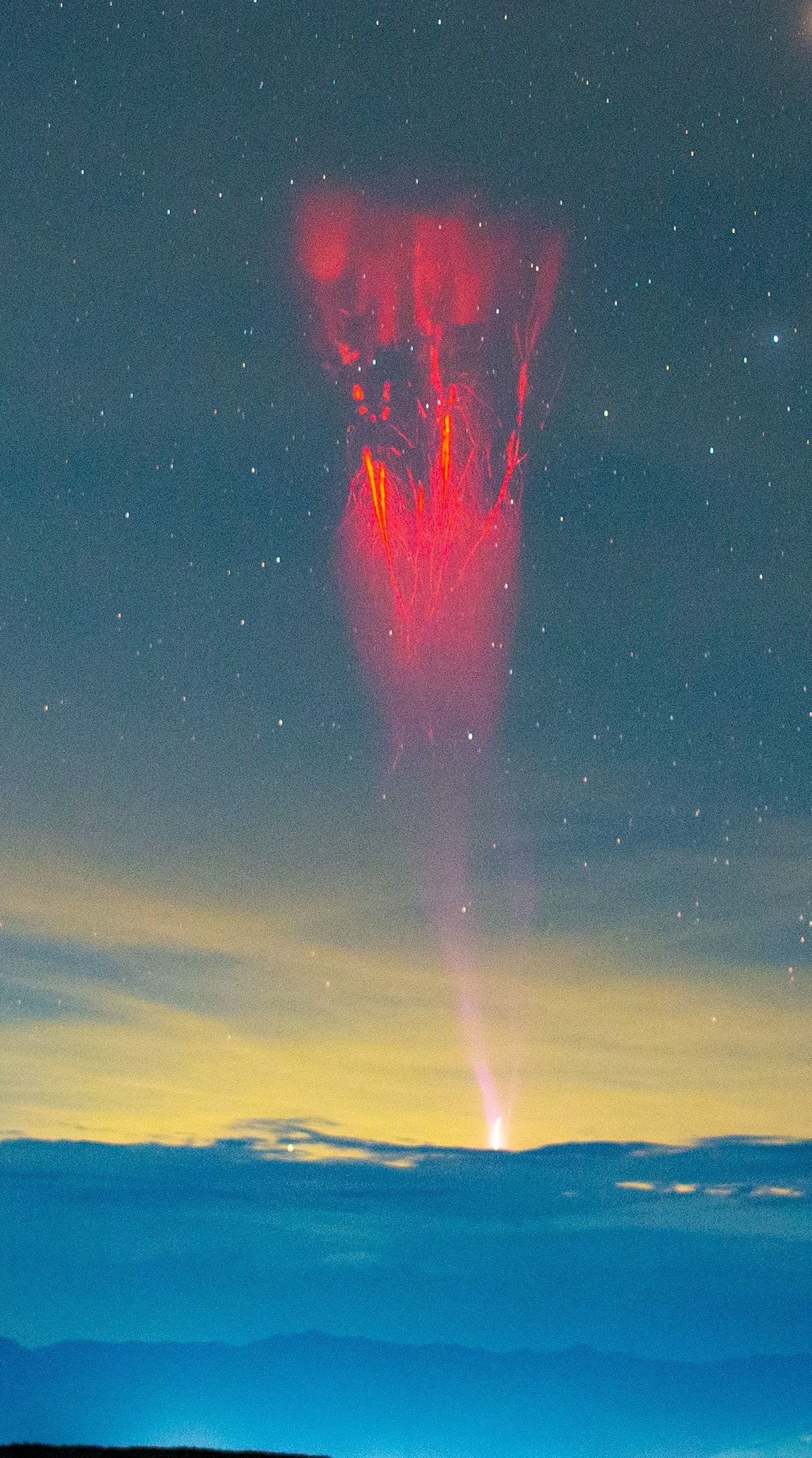 Is there an angry Sith using force lightning in the Tatacoa Desert? This is not science fiction, but a red sprite with multiple streamers! Ordinary lightning occurs when thundercloud particles collide, lose their electrons, and build up negative charge at the cloud bottom. The cloud’s negative charge repels negative charge deeper into the Earth, leaving Earth’s surface positively charged. The opposite charges attract, reaching towards each other and superheating the air into a white strike of plasma. Red sprites are millisecond events triggered by positive cloud-to-ground lightning. They extend up into the mesosphere where the air is too thin for thunder. Their red glow comes from heated molecular nitrogen. There are several potential causes for red sprites, including that the preceding positive lightning exposes the negatively charged cloud core to the positively charged upper atmosphere, allowing those charges to connect. NASA’s Juno has observed sprites on Jupiter, indicating that sprites occur on other planets!