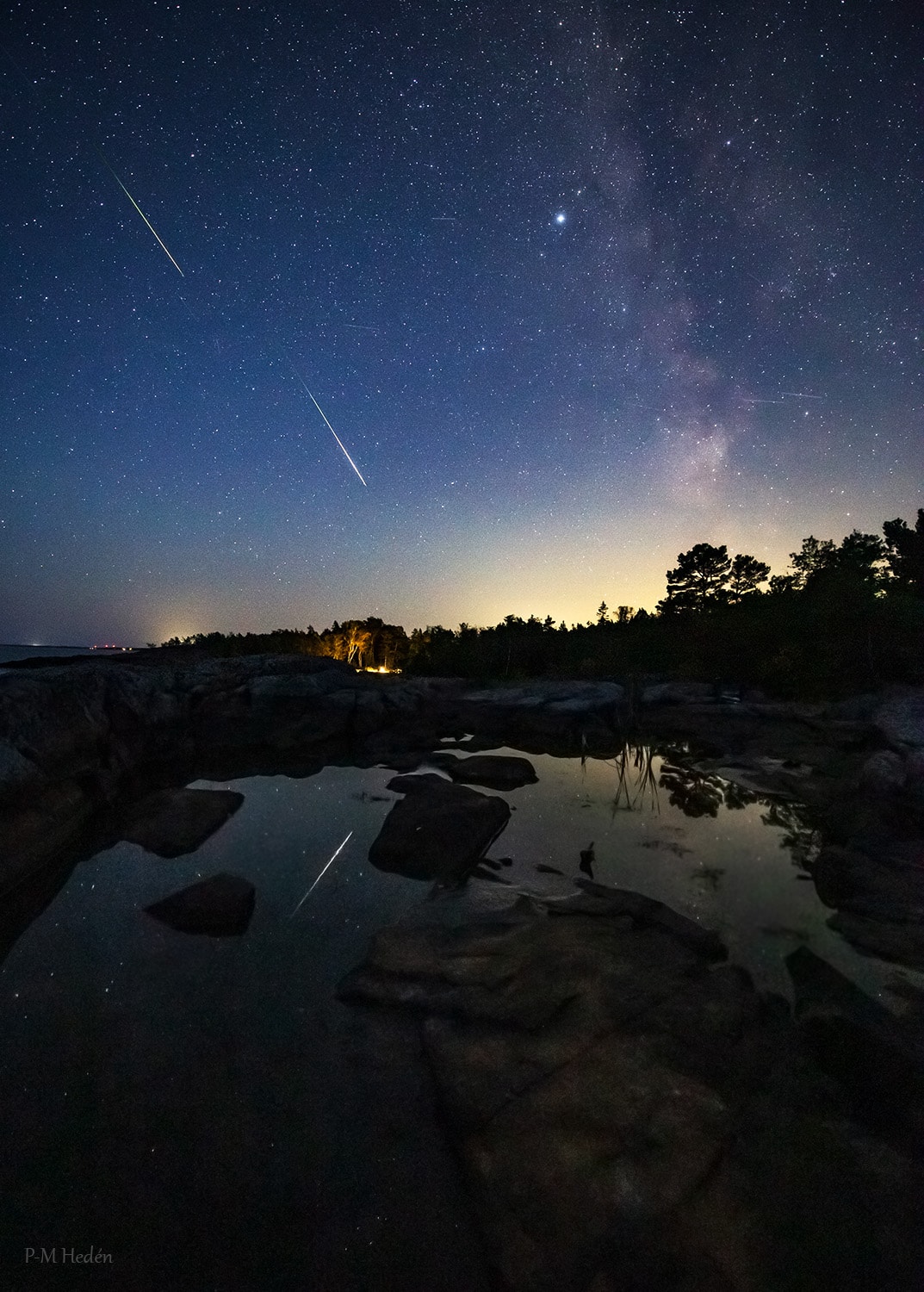 Known for its bright and fast meteors, the annual Perseid Meteor Shower comes to planet Earth's skies from a radiant in the heroic constellation Perseus. The popular northern summer celestial spectacle is created as grains of dust cast off along the orbit of periodic comet 109P/Swift-Tuttle vaporize in Earth's dense atmosphere, tracing brief, but beautiful streaks through the night. Taken near the shower's peak of activity on August 12, this composite image recorded two bright perseid meteors and one meteor's watery reflection from a location near the coastal village of Grisslehamn, Sweden.  Almost as bright as Altair, brightest star on the scene, the meteors appear along with the faint, diffuse background of the Milky Way. This year, the shower's peak activity coincided with a New Moon, so perseid meteor flashes were undiminished by bright moonlight. And for many skywatchers, this night of bright perseid meteors followed their viewing of the silhouette of the New Moon in a much anticipated solar eclipse.  Growing Gallery: Solar Eclipse of 2026 August 12