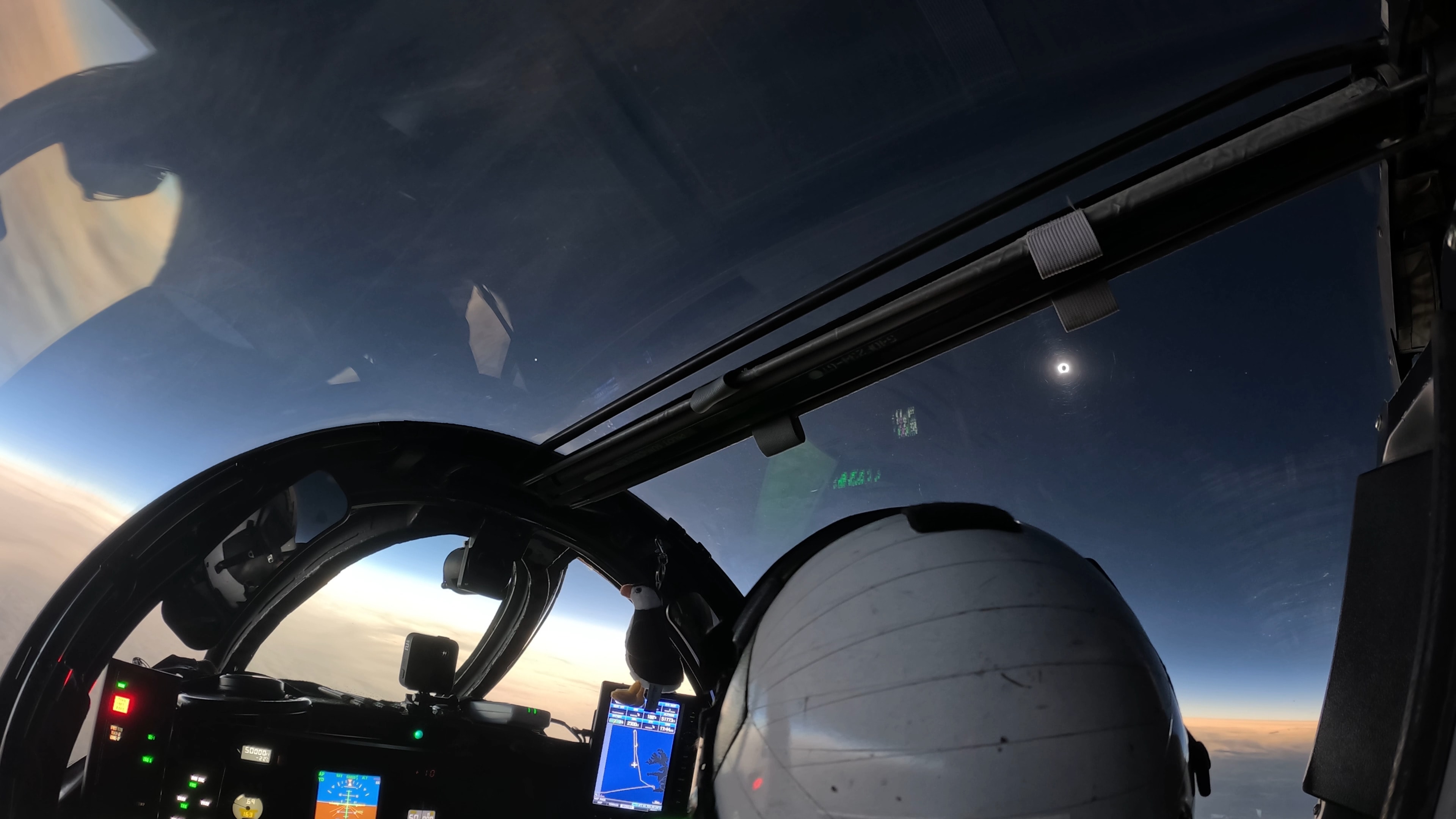 Chasing the shadow of a New Moon, NASA’s WB-57F high altitude research aircraft took to the skies off the coast of Iceland on August 12 to observe a total solar eclipse. At 50,000 feet the aircraft was piloted along the precisely determined path of totality to maximize its time in the Moon’s shadow. A suite of high-resolution cameras on board was able to record eclipse data from above the clouds, dust, and atmospheric water vapor that interfere with observations made closer to the ground. This view from the cockpit, taken from an inflight video, captures the solar corona emerging at the beginning of totality. The sky appears dark in the shadow of the Moon. Venus is shining left of center in the video frame, while Jupiter and Mercury are just visible to the right of the eclipsed Sun. But the sky is bright along the distant horizon below, beyond the reach of the Moon's shadow.  APOD's main NASA site is moving: From apod.nasa.gov to science.nasa.gov/apod